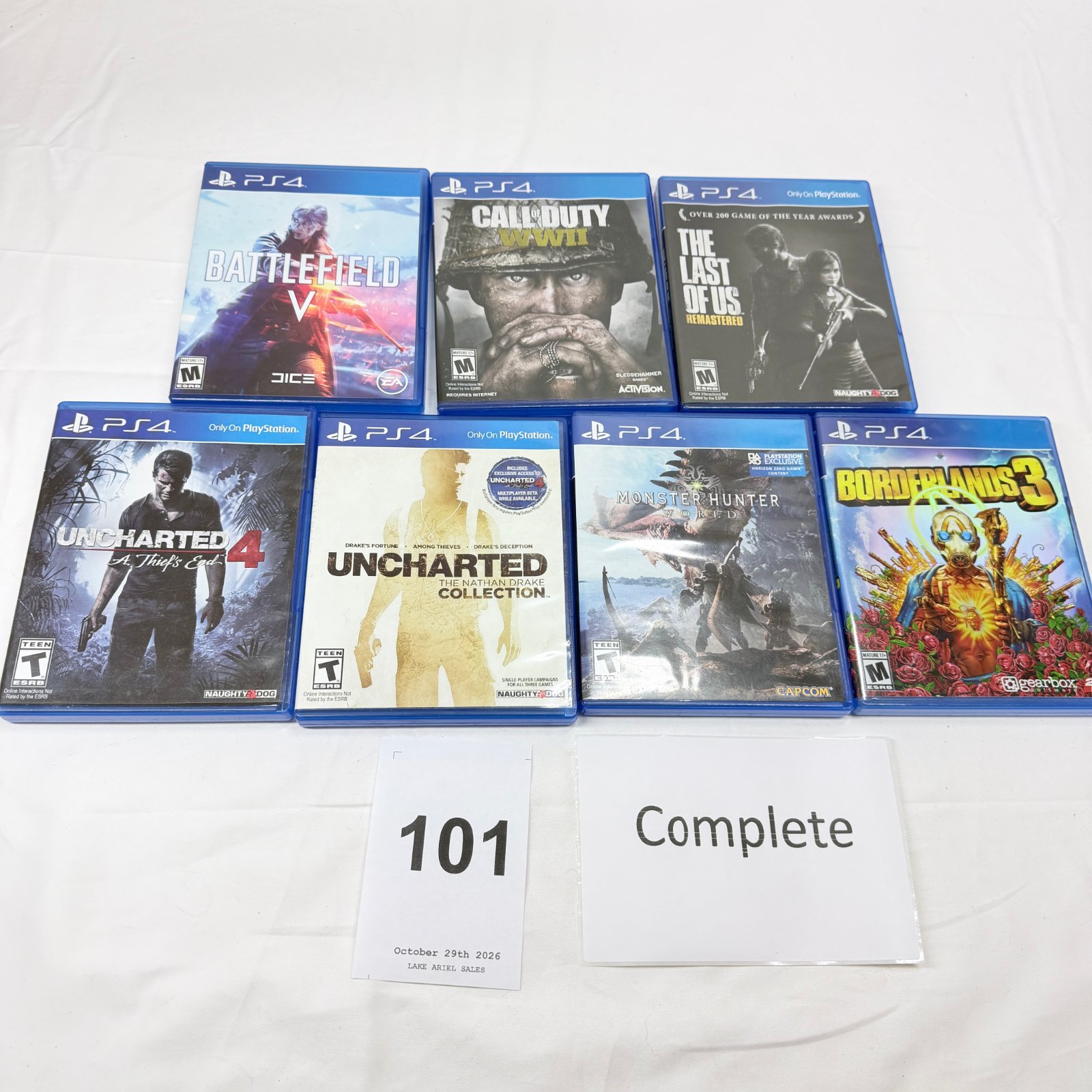 Lot 101: PS4 game lot (7): Battlefield V, Call of Duty WWII, The Last of Us Remastered, Uncharted 4, Uncharted Nathan Drake Collection, Monster Hunter World, Borderlands 3