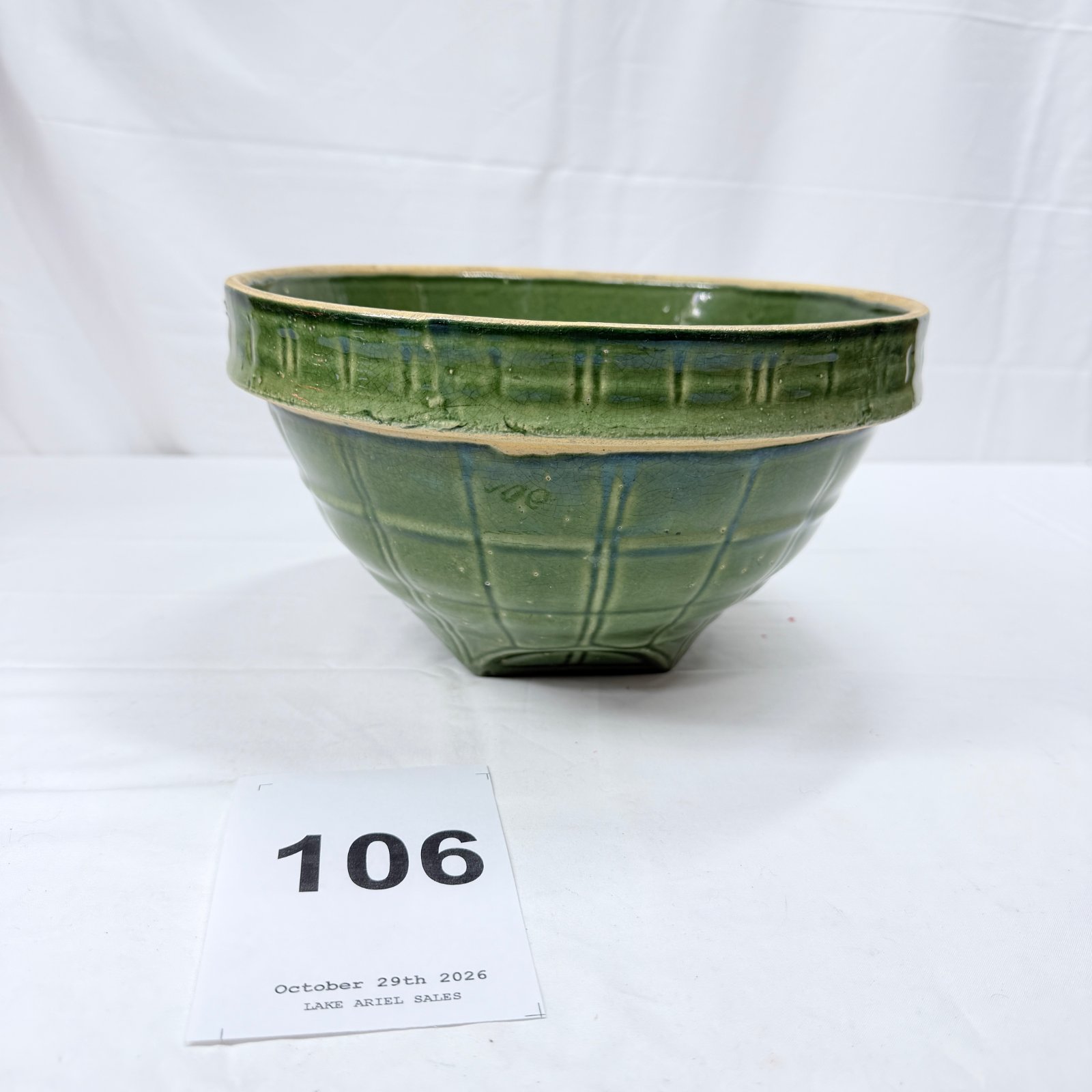 Lot 106: Green glazed stoneware mixing bowl with paneled plaid design, impressed mark on base