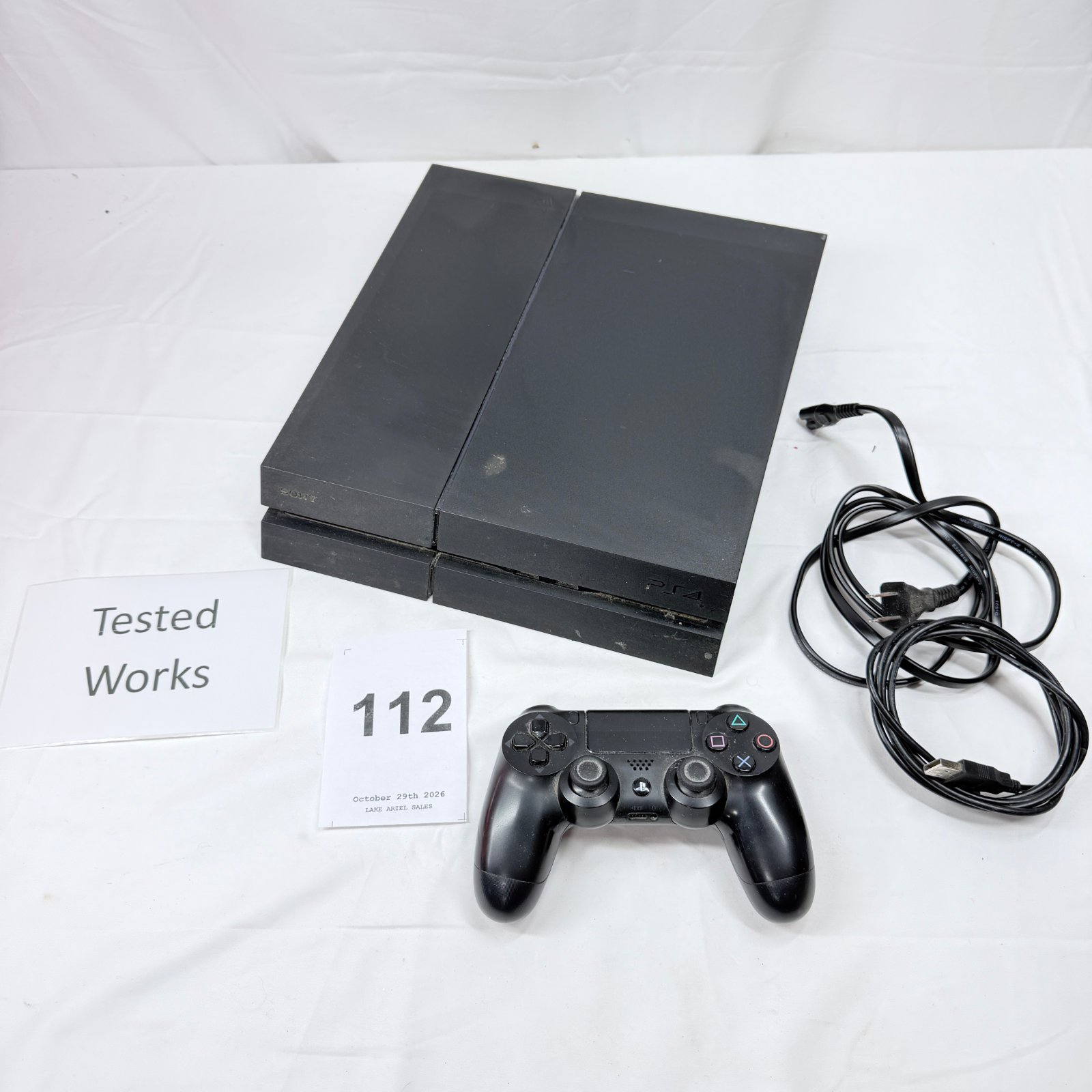 Lot 112: Sony PlayStation 4 (CUH-1215A) console with DualShock 4 controller and power cable, tested working