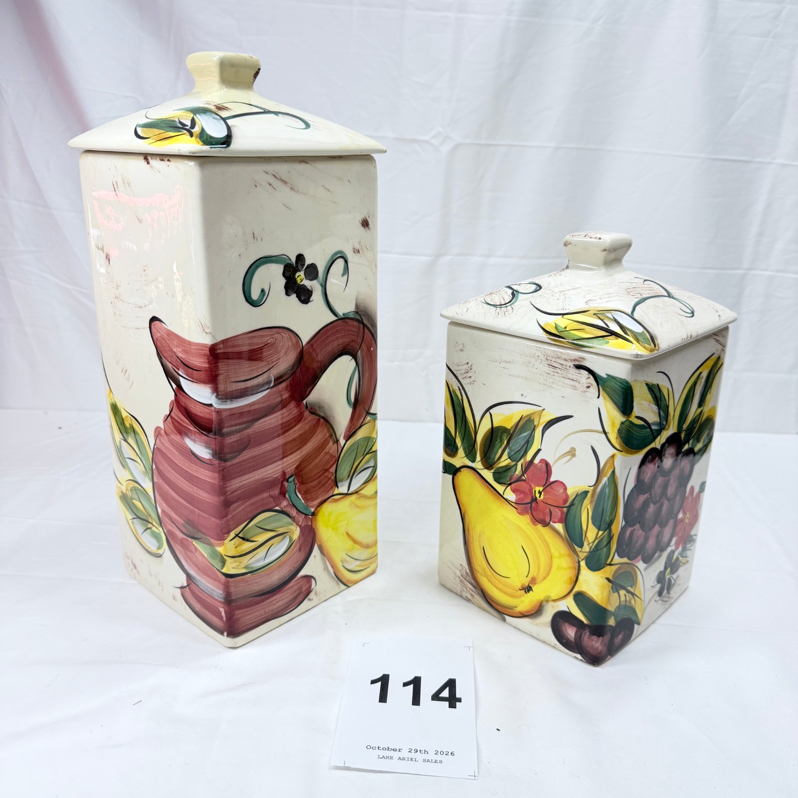 Lot 114: Hand-painted ceramic lidded canister set, pitcher and fruit motif, pagoda-shaped lids, pair