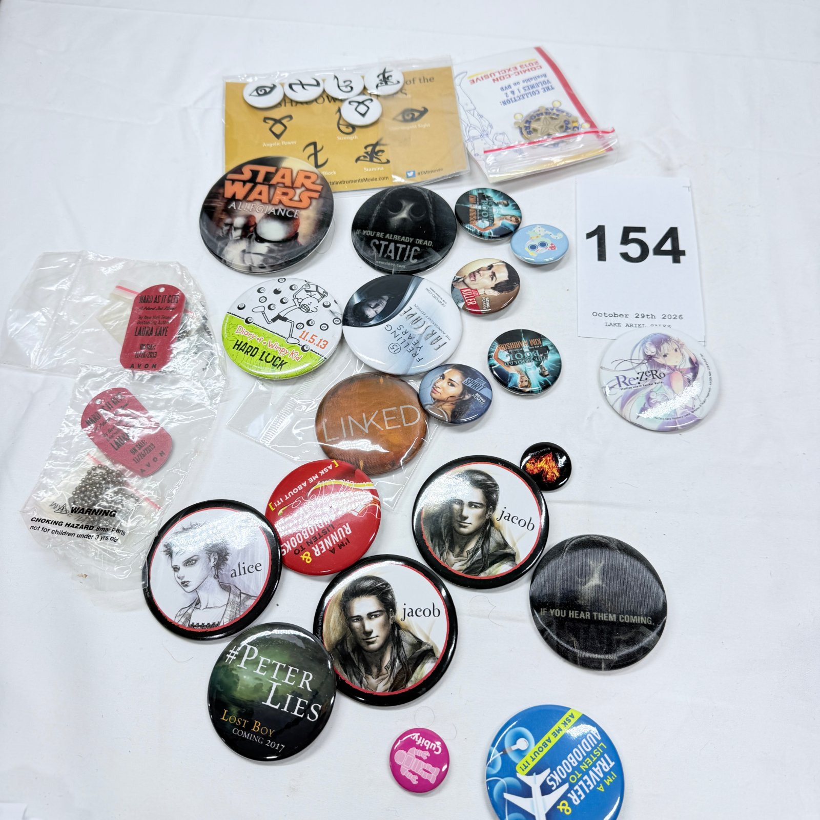 Lot 154: Mixed promo pinback button lot: Star Wars, Mortal Instruments, Twilight "Jacob/Alice", Re:Zero, Kim Harrison, Diary of a Wimpy Kid, Being Human