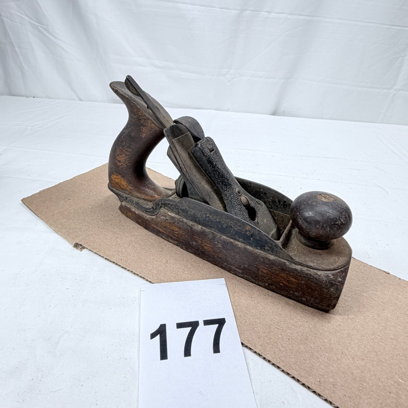 Lot 177: Early 1900s wooden jack plane with cast iron frog and lever cap, transitional-style woodworking tool