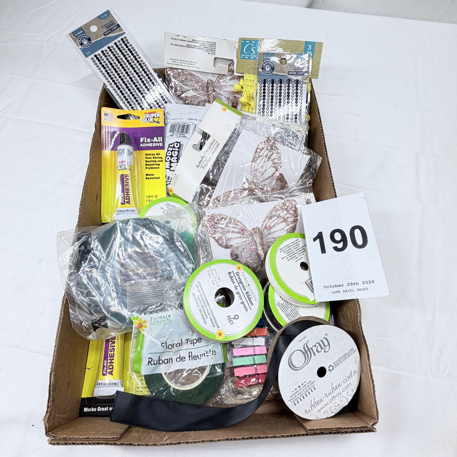 Lot 190: Mixed craft supply lot: Offray & Floral Garden ribbon, glitter butterfly decorations, Crafter's Closet gem strips, Super Glue Fix-All adhesive, floral tape