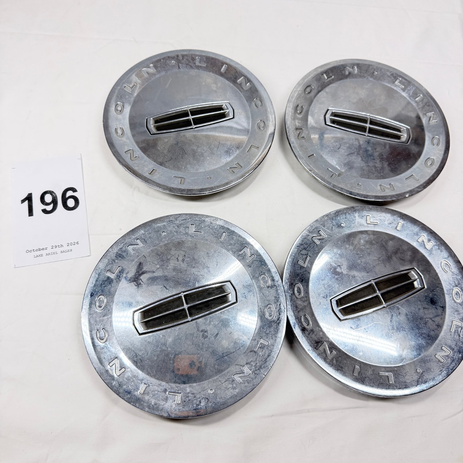 Lot 196: Lincoln wheel center caps, set of 4, Ford part 4W13-1A096-CA