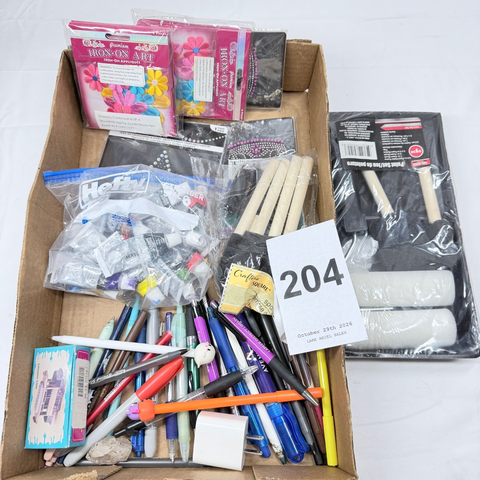 Lot 204: Craft supply lot: assorted pens/pencils, acrylic paint tubes, Iron-On Art floral appliques, rhinestone stickers, foam brushes, paint roller set