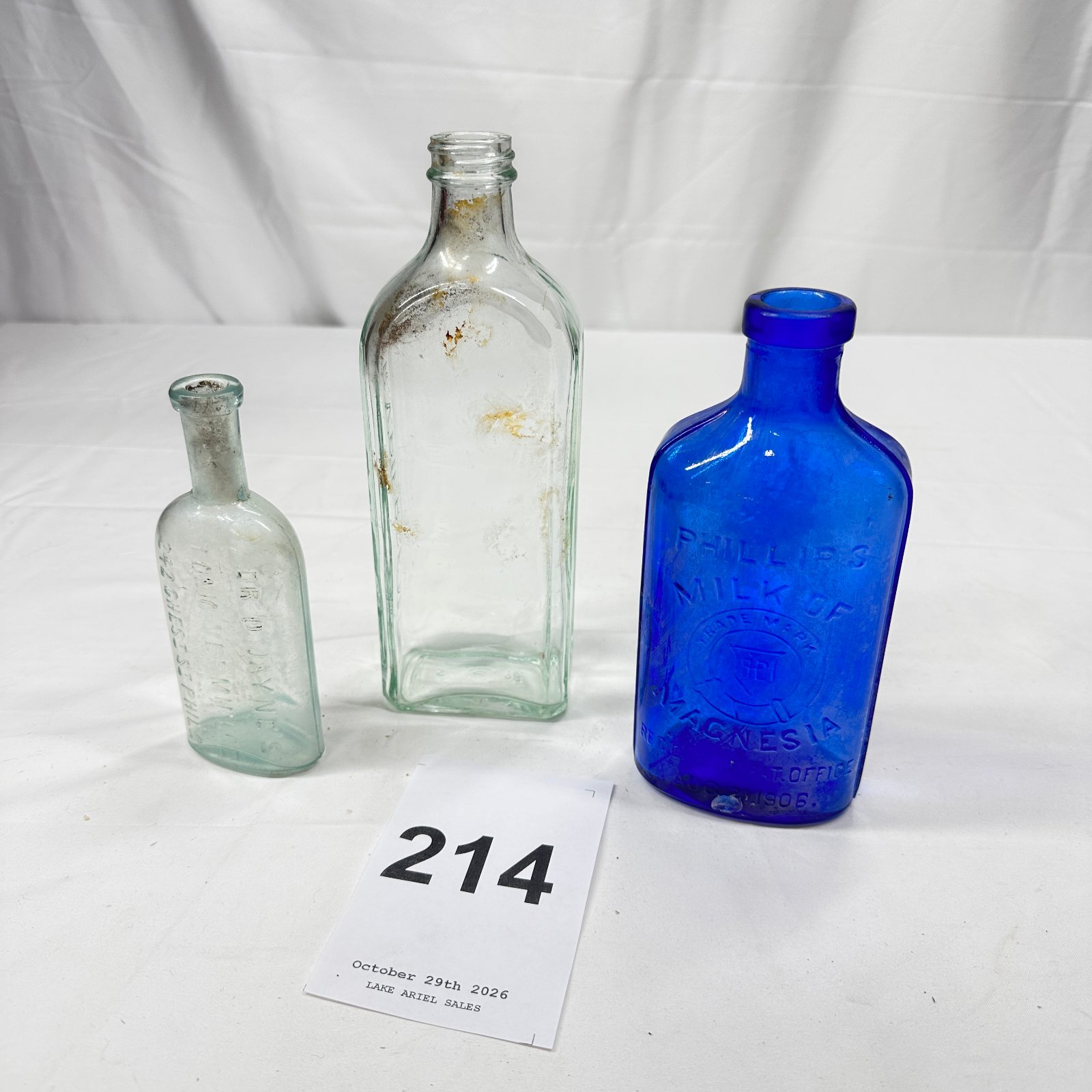 Lot 214: Late 1800s-1906 antique medicine bottle lot: Phillips' Milk of Magnesia cobalt blue bottle, Dr. D. Jayne's Tonic Vermifuge, and R.V. Pierce M.D. bottle