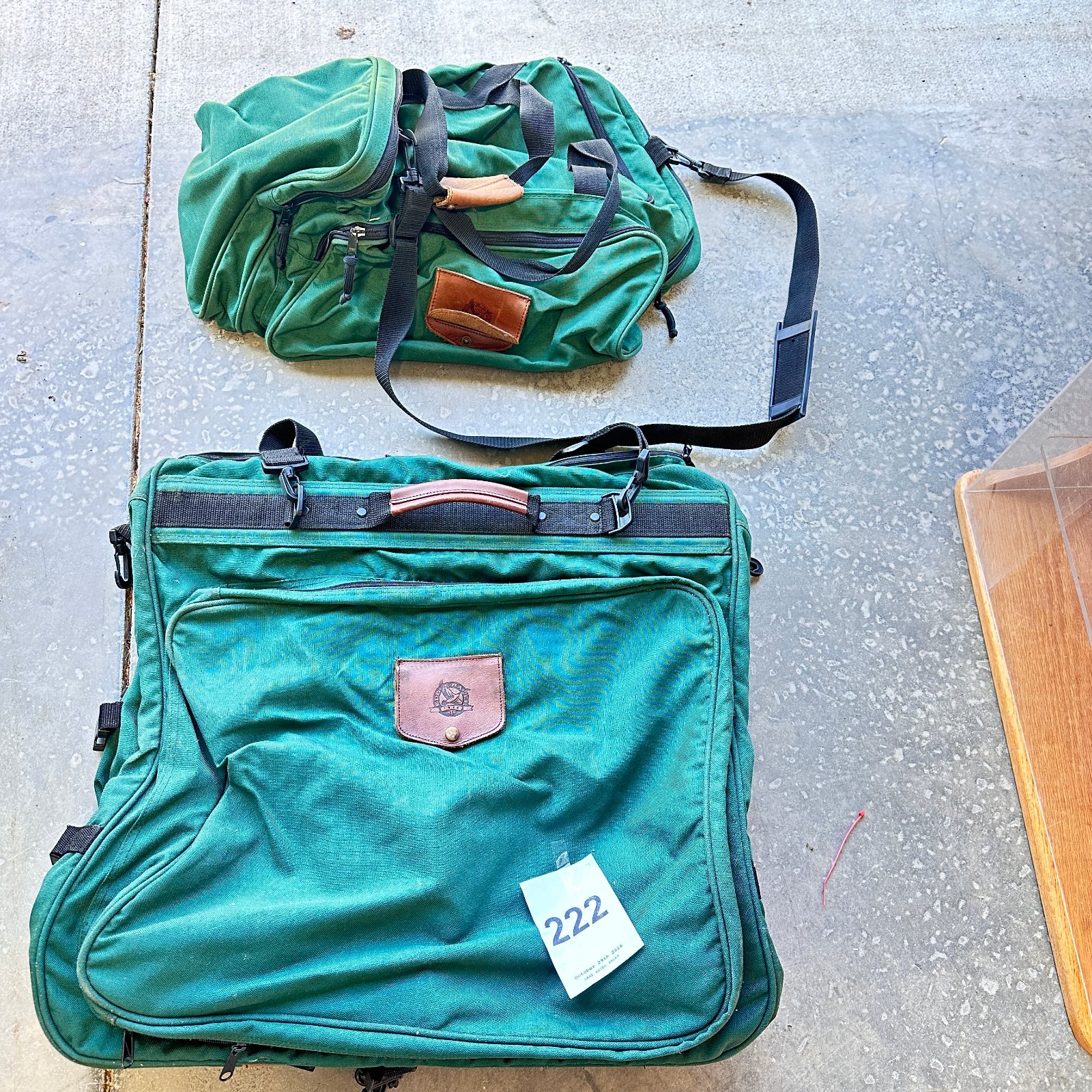 Lot 222: Eddie Bauer green canvas garment bag with leather trim and matching backpack/duffel, two-piece luggage set