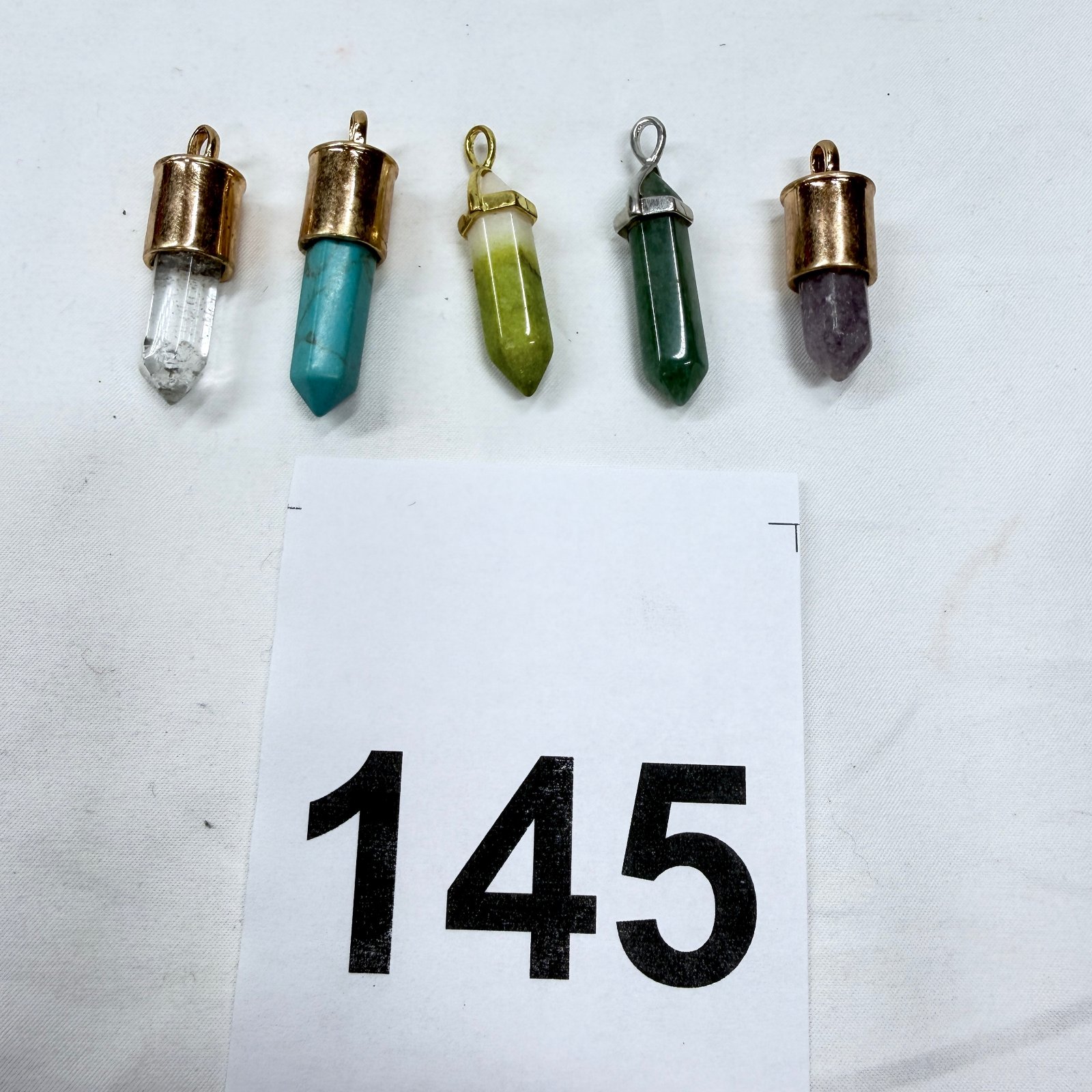 Lot 145: Gemstone crystal point pendants, quartz turquoise jade aventurine and amethyst, set of 5
