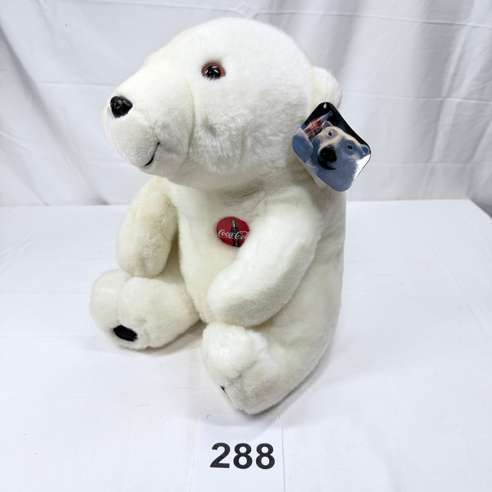 Lot 288: 1993 Coca-Cola Plush Polar Bear sitting stuffed animal with bottle cap button and hang tag
