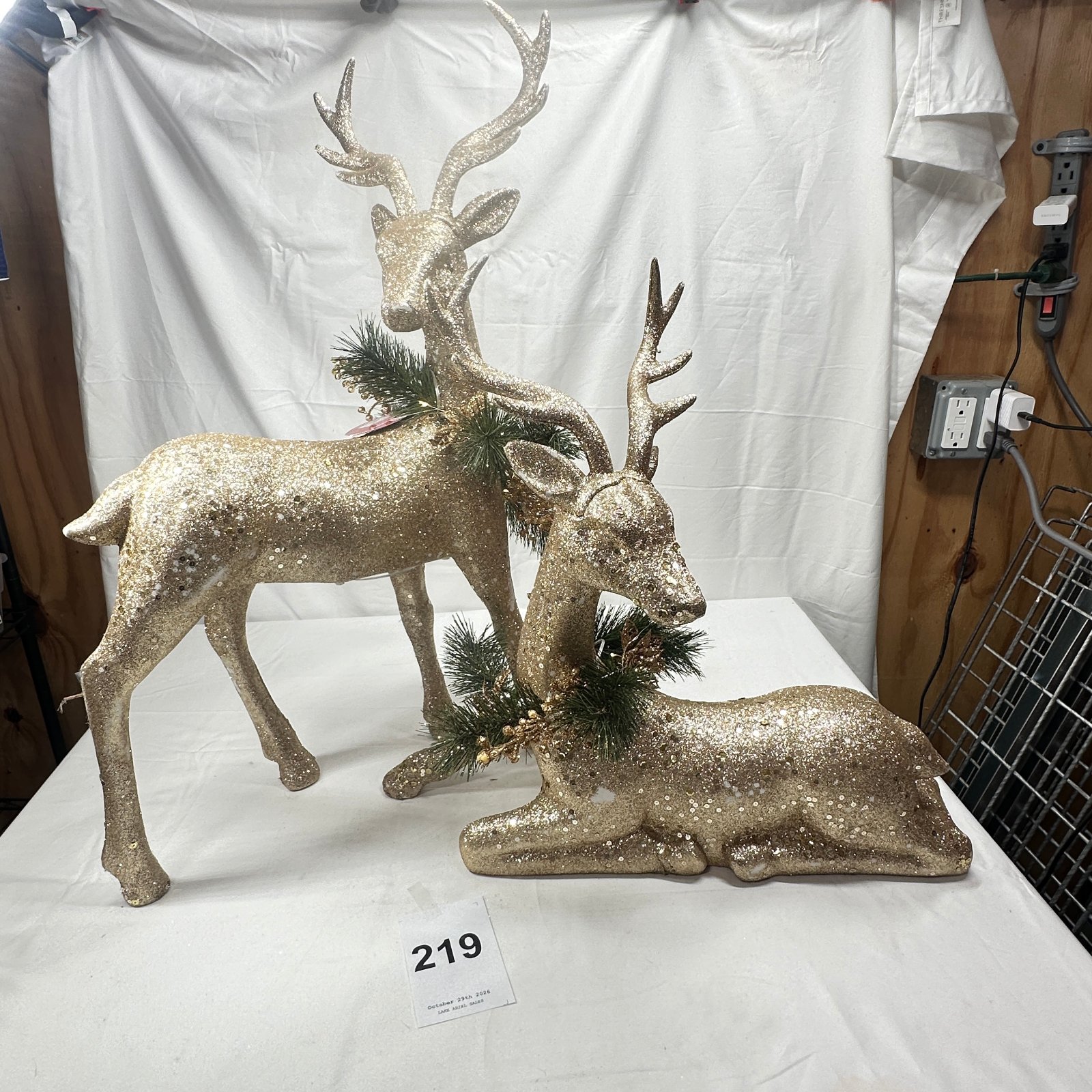 Lot 219: Glitter LED Reindeer figurine pair with pine sprig accents, light-up tabletop Christmas decor set of 2