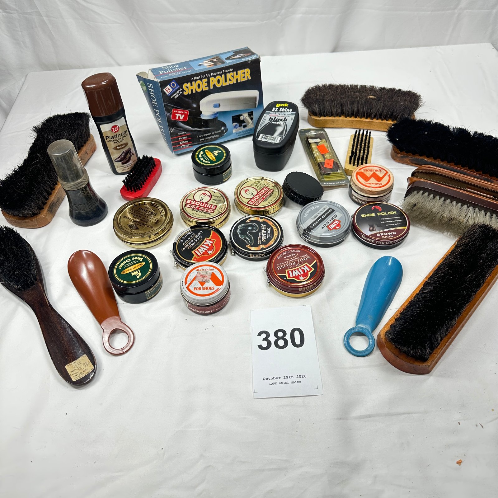 Lot 380: Mixed shoe shine lot: Kiwi, Esquire, Meltonian, Panther tins with brushes, daubers, and B&O "As Seen on TV" battery-operated Shoe Polisher
