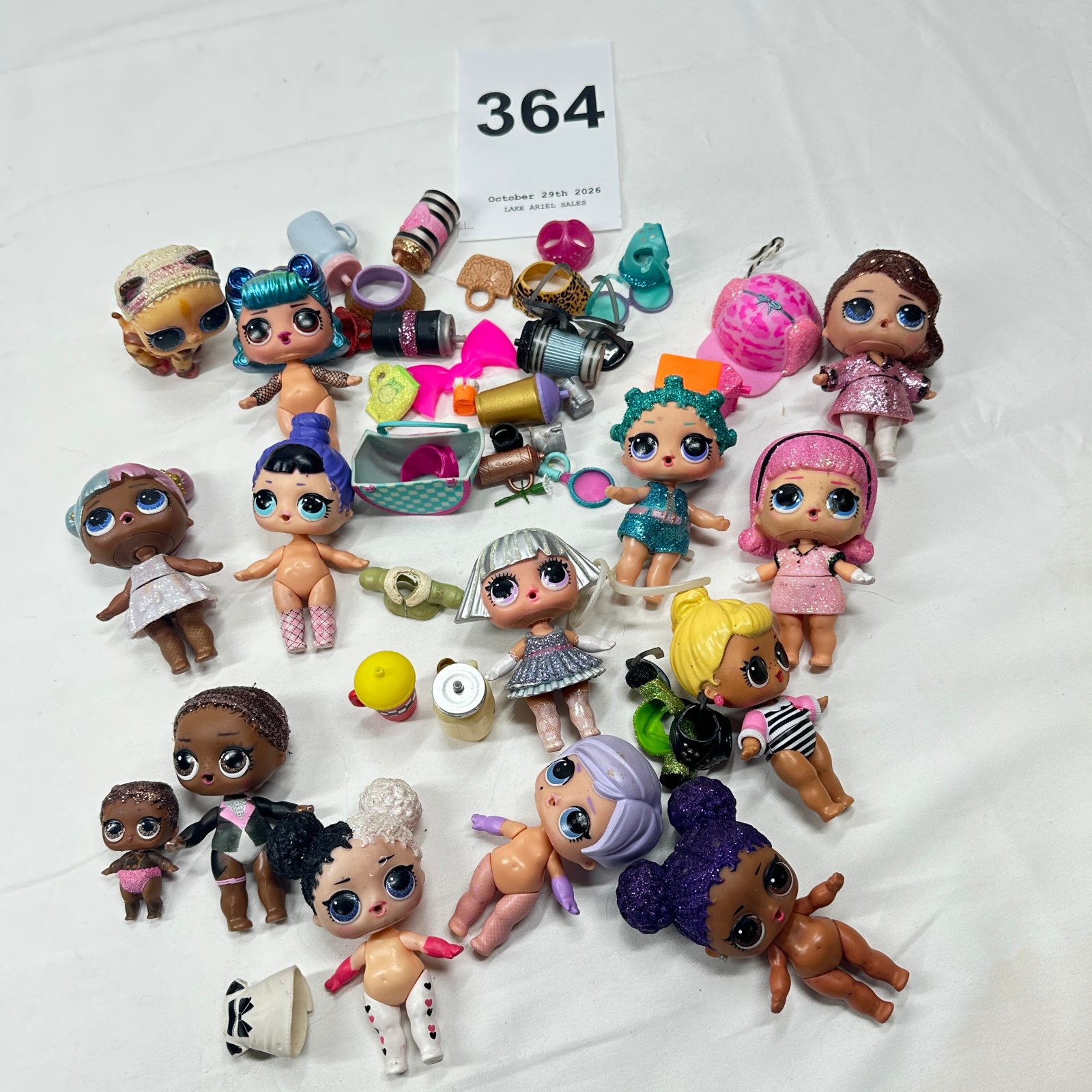 Lot 364: MGA Entertainment L.O.L. Surprise! dolls and accessories lot, 15 dolls with shoes, bags, and glitter outfits
