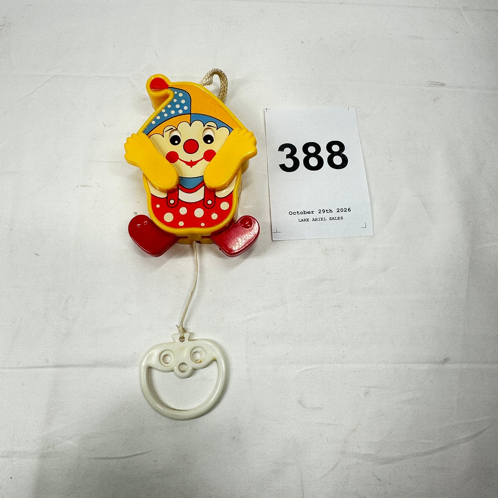 Lot 388: 1970s Fisher-Price Jolly Jalopy-style Clown pull-toy baby crib musical pull with teether ring, plastic character pull toy