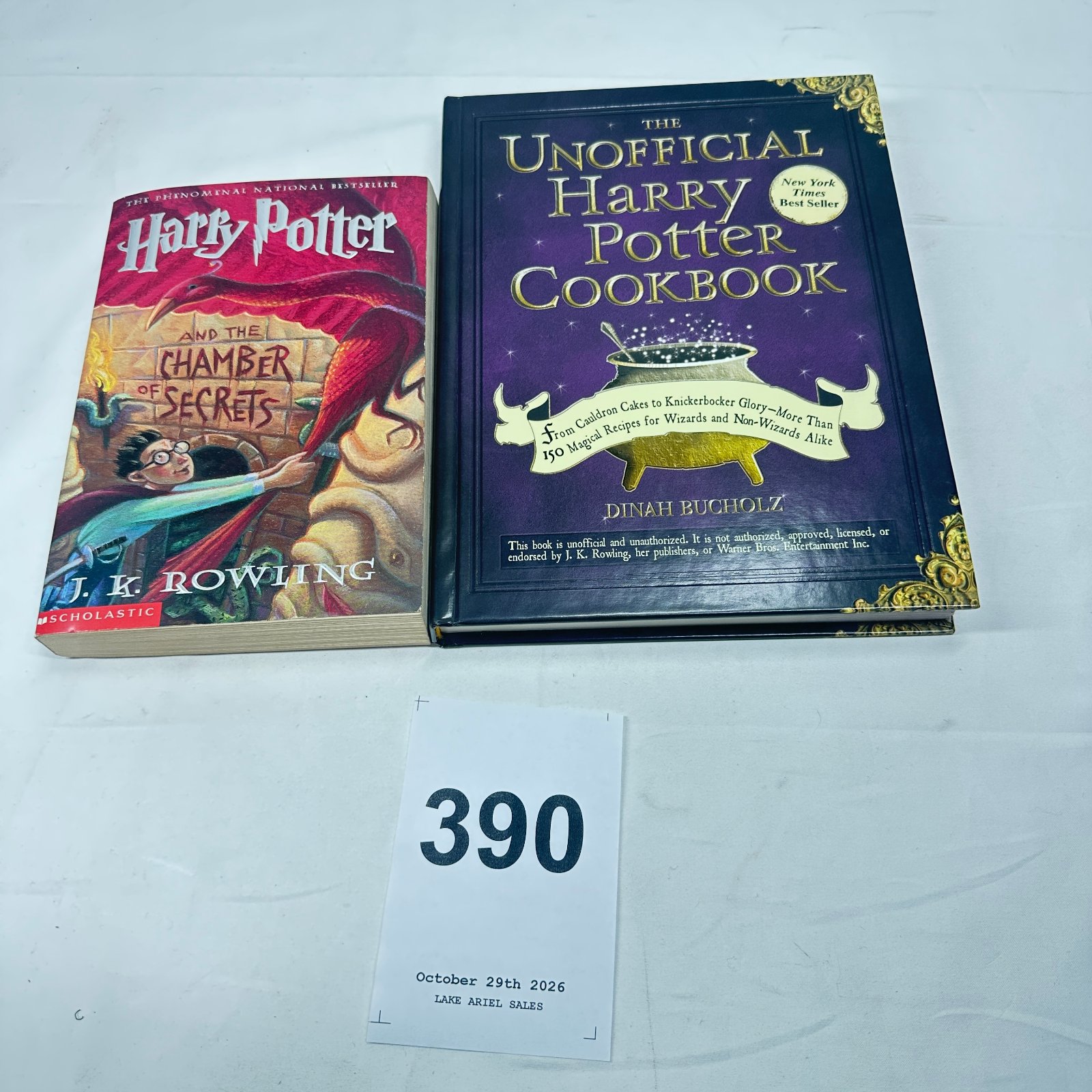 Lot 390: J.K. Rowling "Harry Potter and the Chamber of Secrets" Scholastic paperback and Dinah Bucholz "The Unofficial Harry Potter Cookbook" hardcover, set of 2