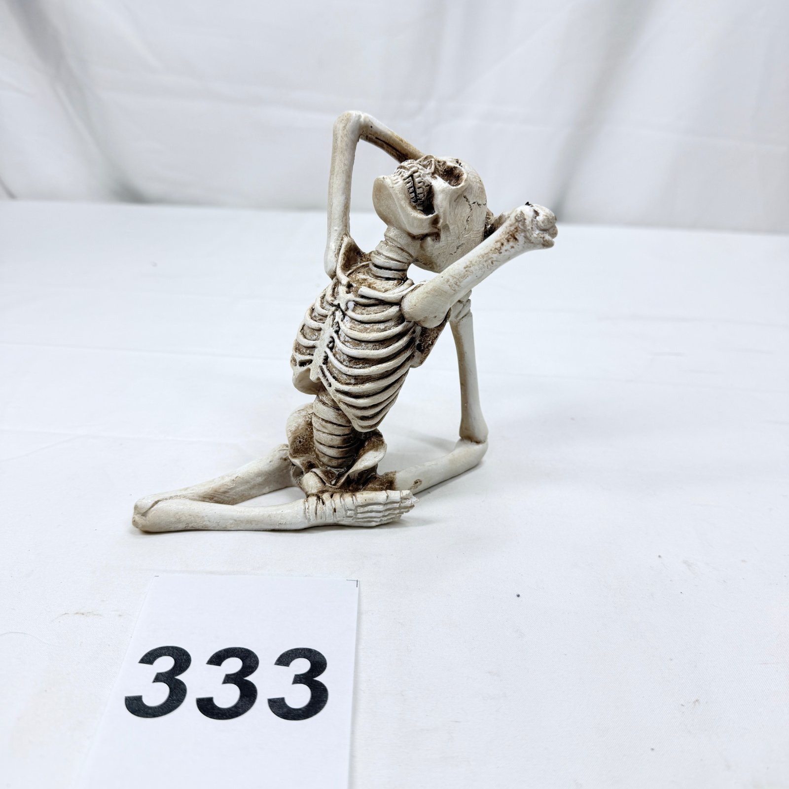 Lot 333: Resin skeleton figurine in yoga stretching pose, novelty decorative statue