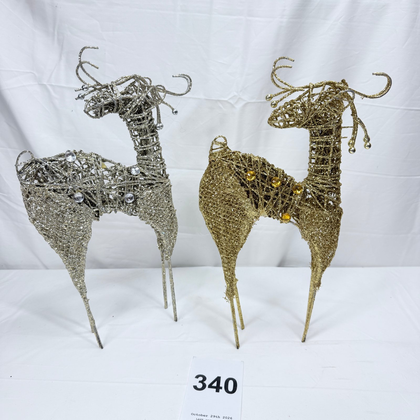 Lot 340: Pair of glitter wire rattan-style reindeer figurines, silver and gold with rhinestone accents, approx. 15in