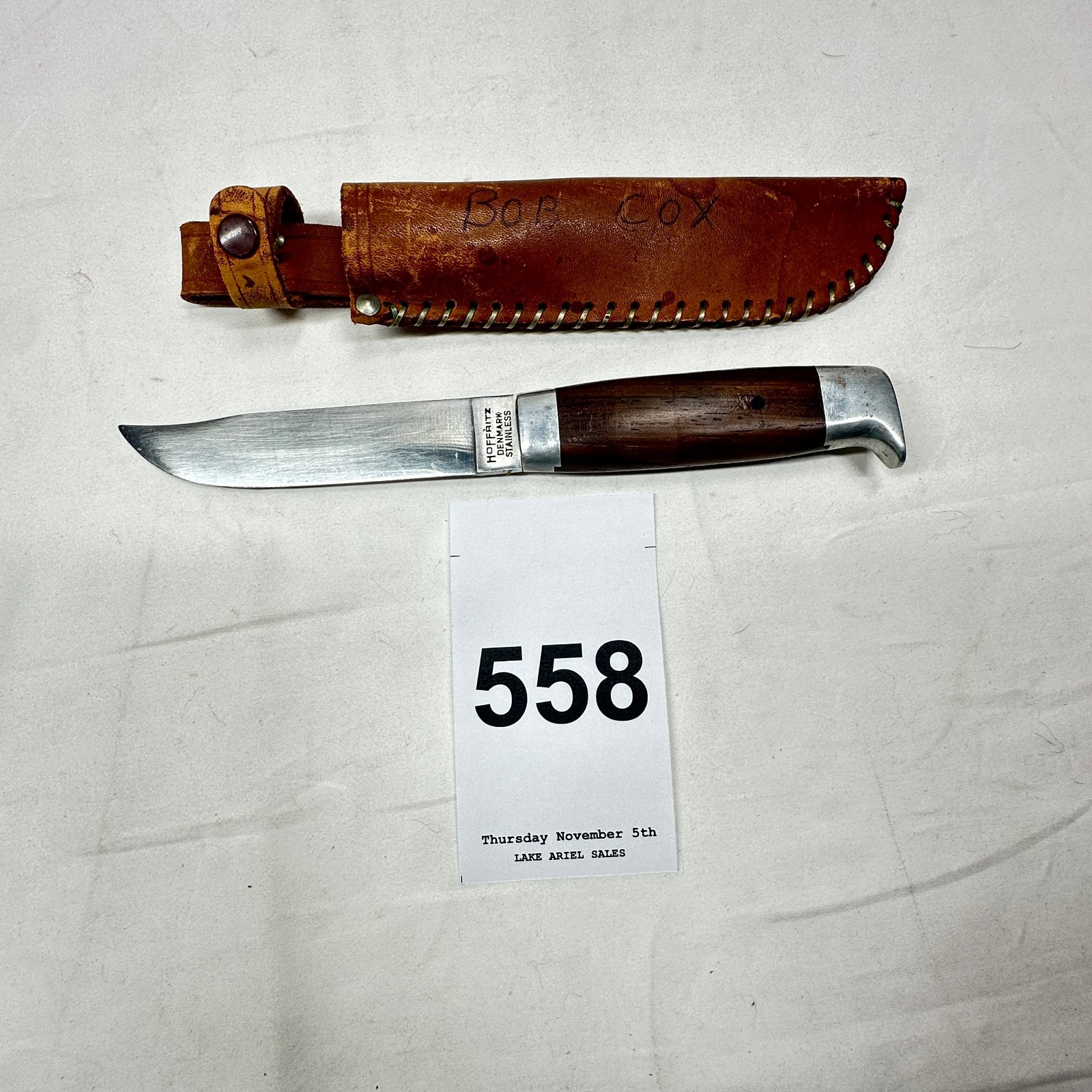 Lot 558: Hoffritz Denmark Stainless fixed-blade hunting knife with rosewood handle and leather sheath