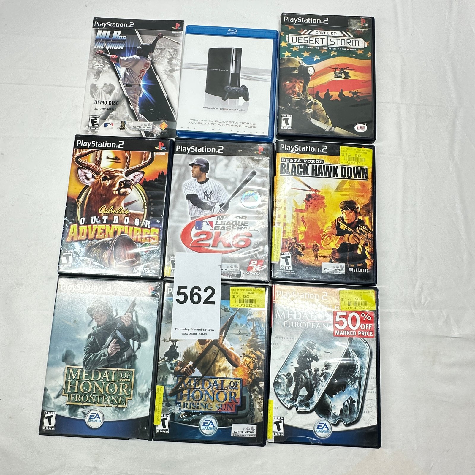 Lot 562: PlayStation 2 game lot of 9: Medal of Honor Frontline/Rising Sun/European Assault, Delta Force Black Hawk Down, Desert Storm, MLB 2K6, Cabela's, plus PS3 Blu-ray promo disc