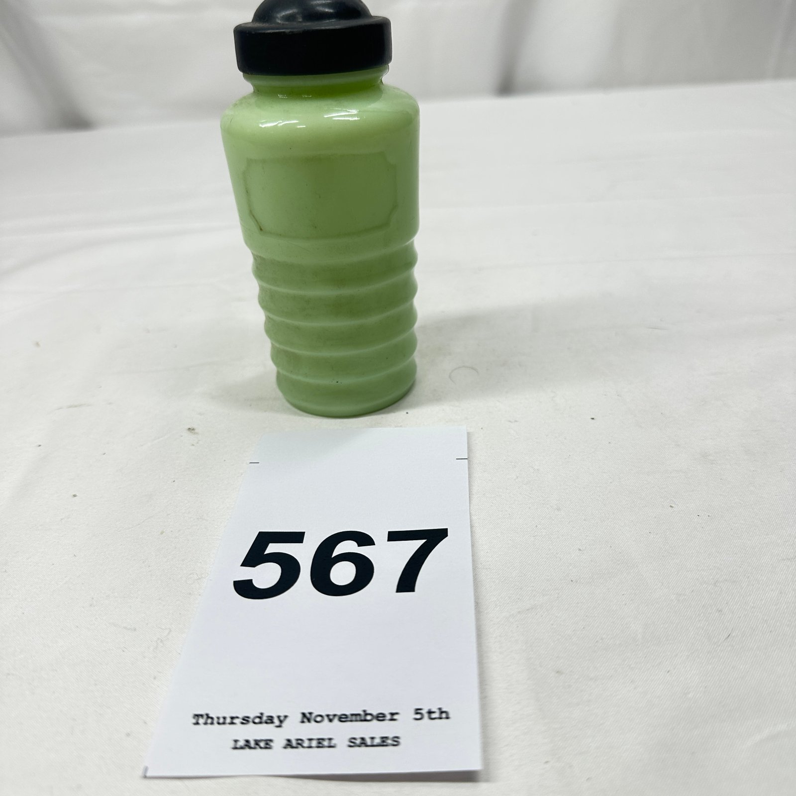Lot 567: Mid-century jadeite glass ribbed sugar shaker with black bakelite lid, kitchenware