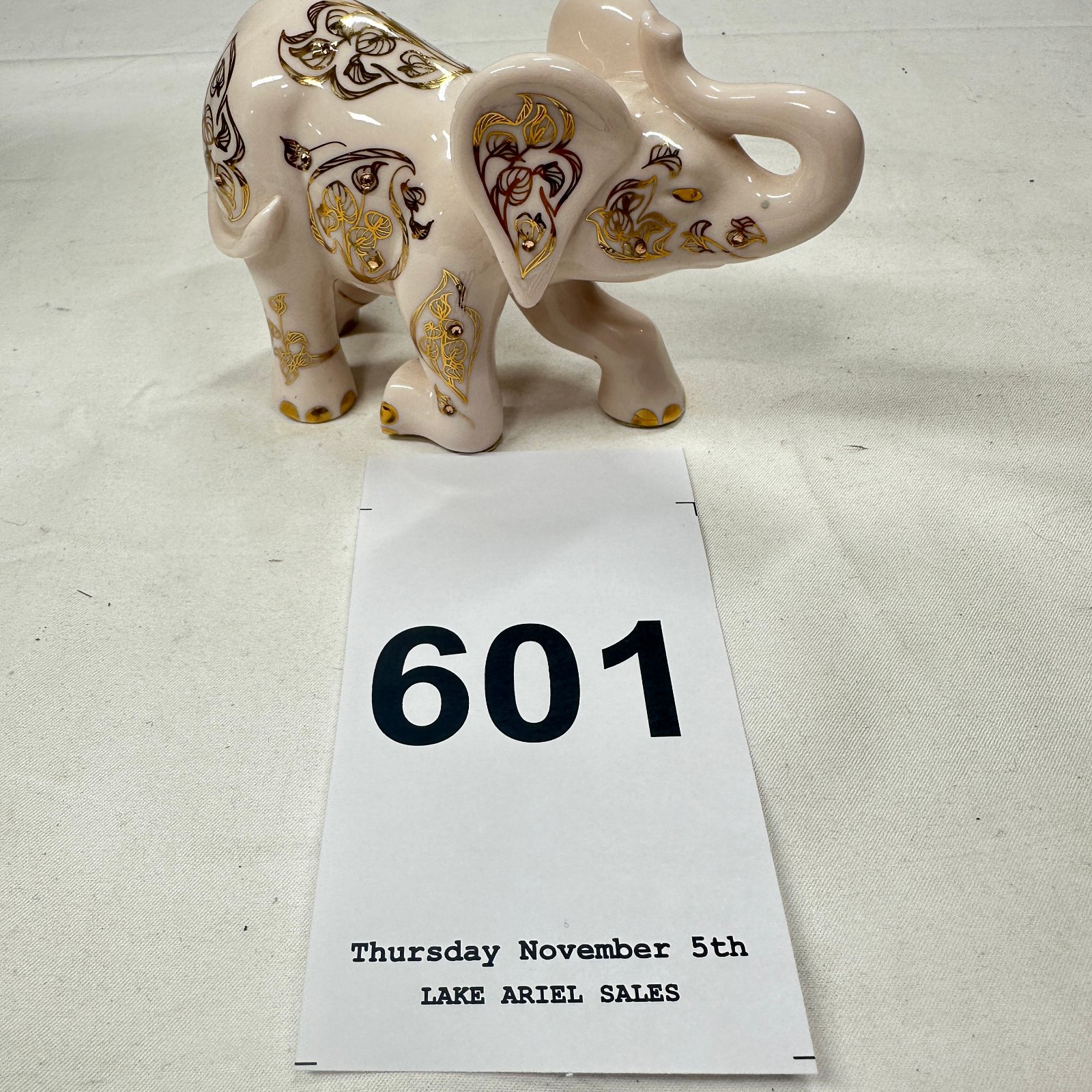 Lot 601: The Hamilton Collection porcelain elephant figurine with gold gilt and crystal accents, model 09-10124-004