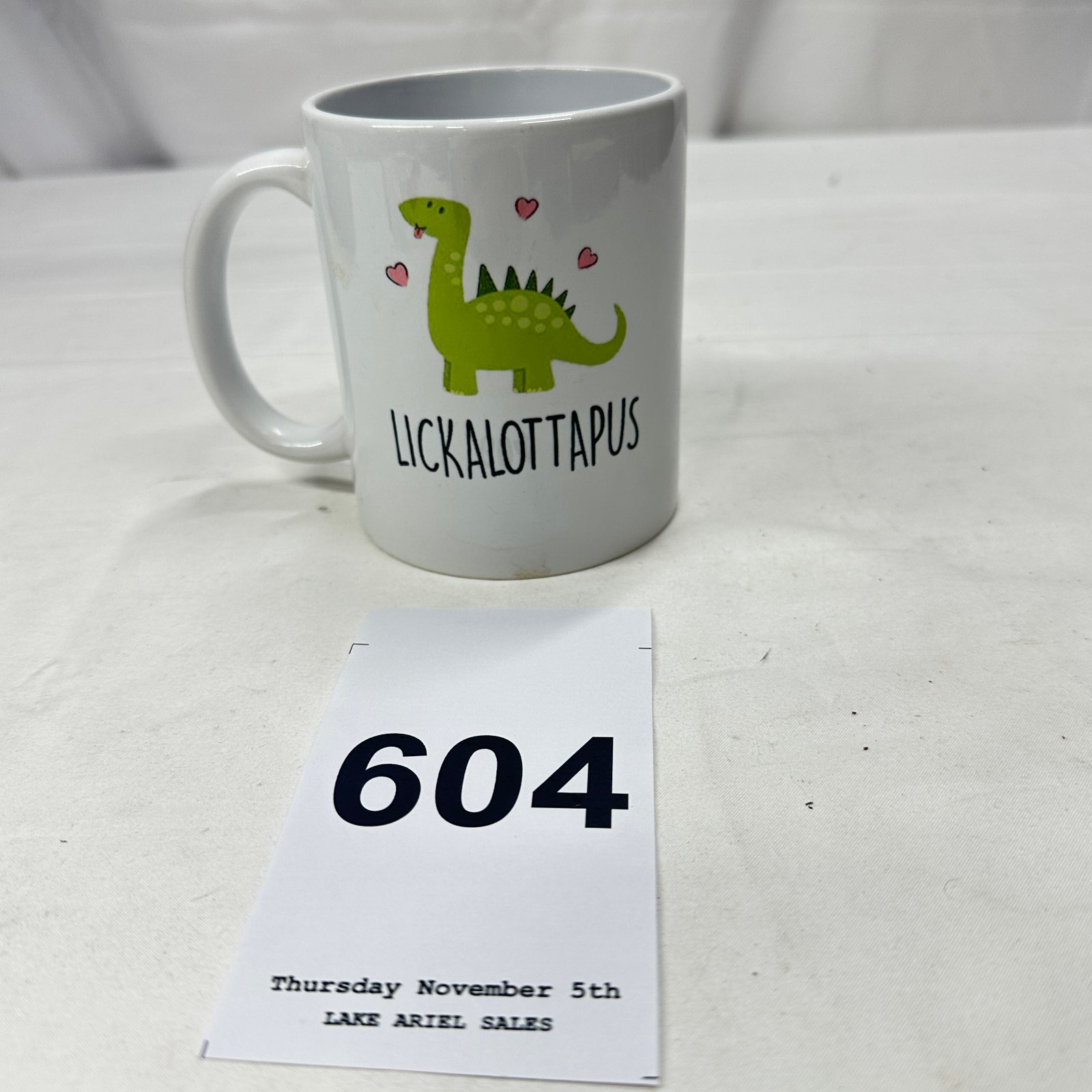 Lot 604: Lickalottapus" dinosaur novelty ceramic coffee mug, Brontosaurus pun design