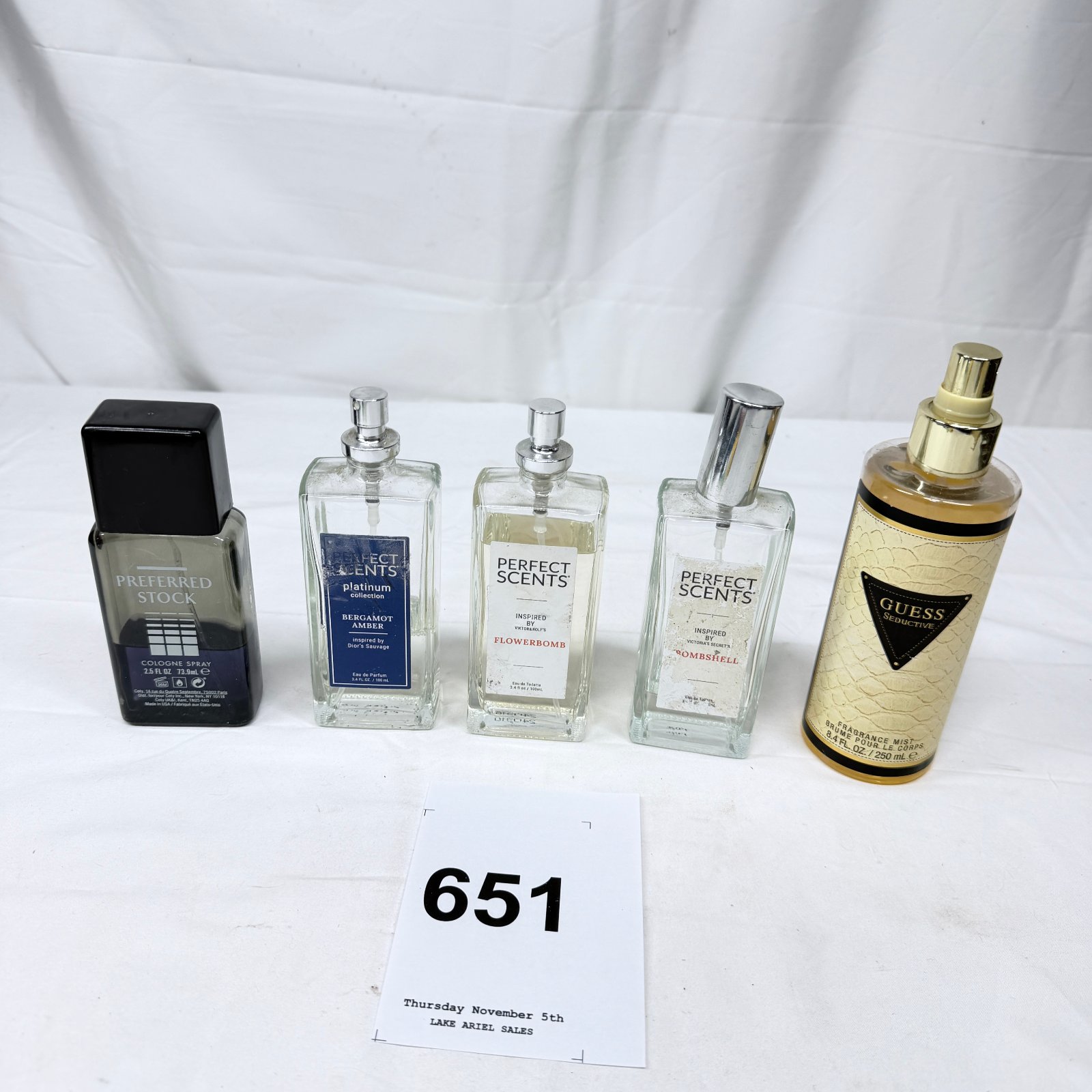 Lot 651: Perfume lot: Preferred Stock Cologne Spray, Perfect Scents (Bergamot Amber, Flowerbomb, Bombshell inspired), and Guess Seductive Fragrance Mist, 5 bottles