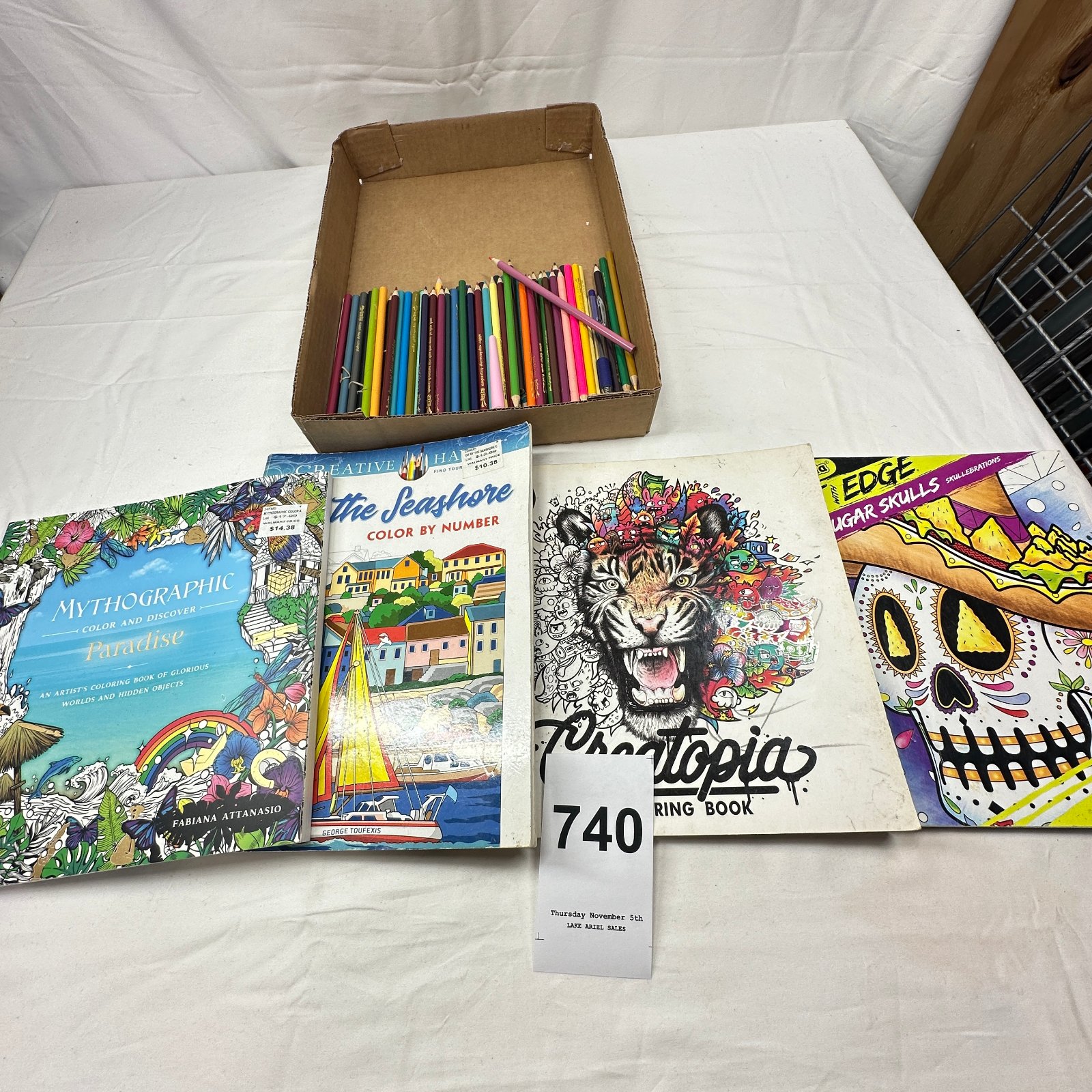 Lot 740: Adult coloring books lot (Mythographic Paradise, Seashore Color by Number, Creatopia, Sugar Skulls) with colored pencils