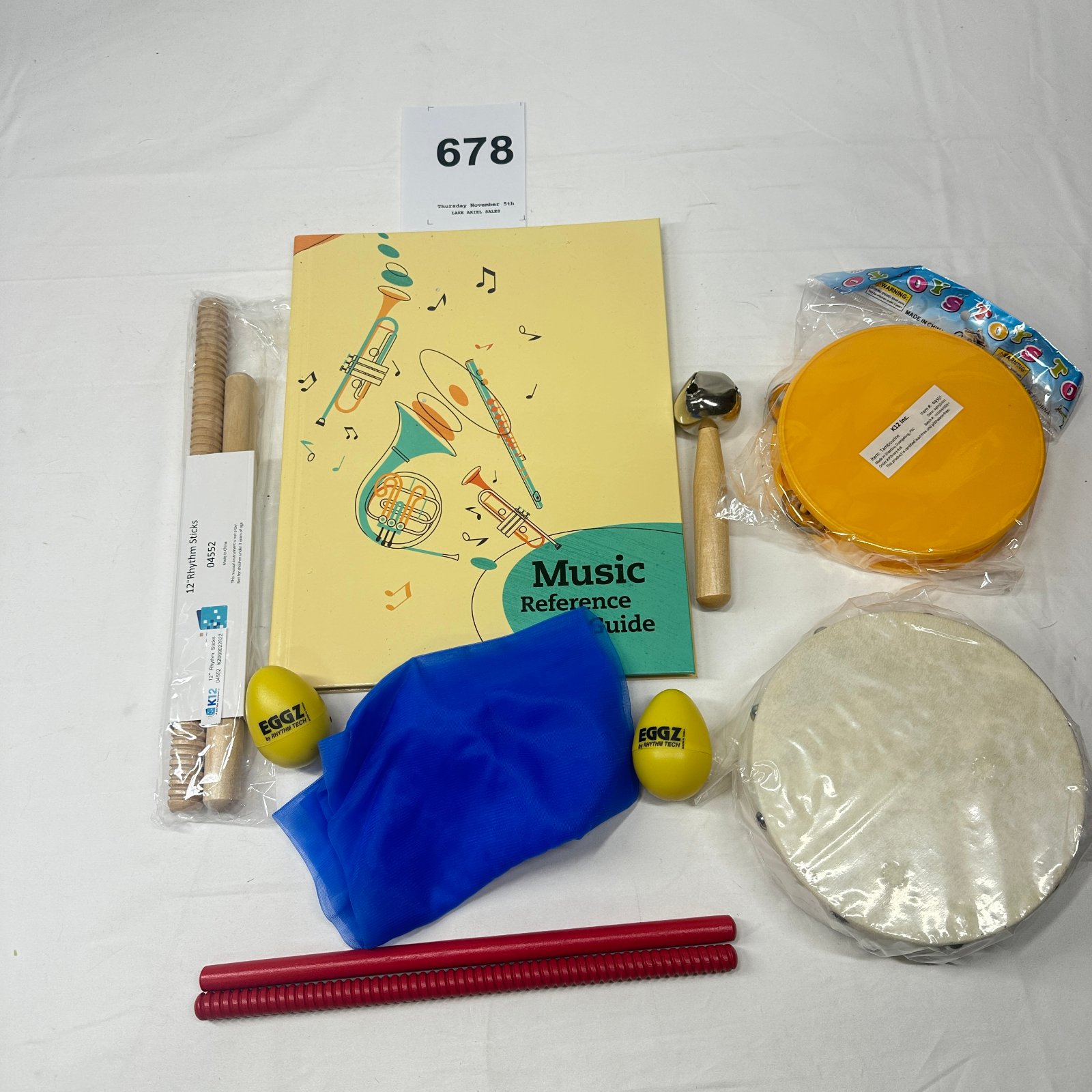 Lot 678: K12 Classroom Music Instrument Set: Rhythm Sticks, Eggz Shakers, Tambourines, Jingle Bell & Music Reference Guide