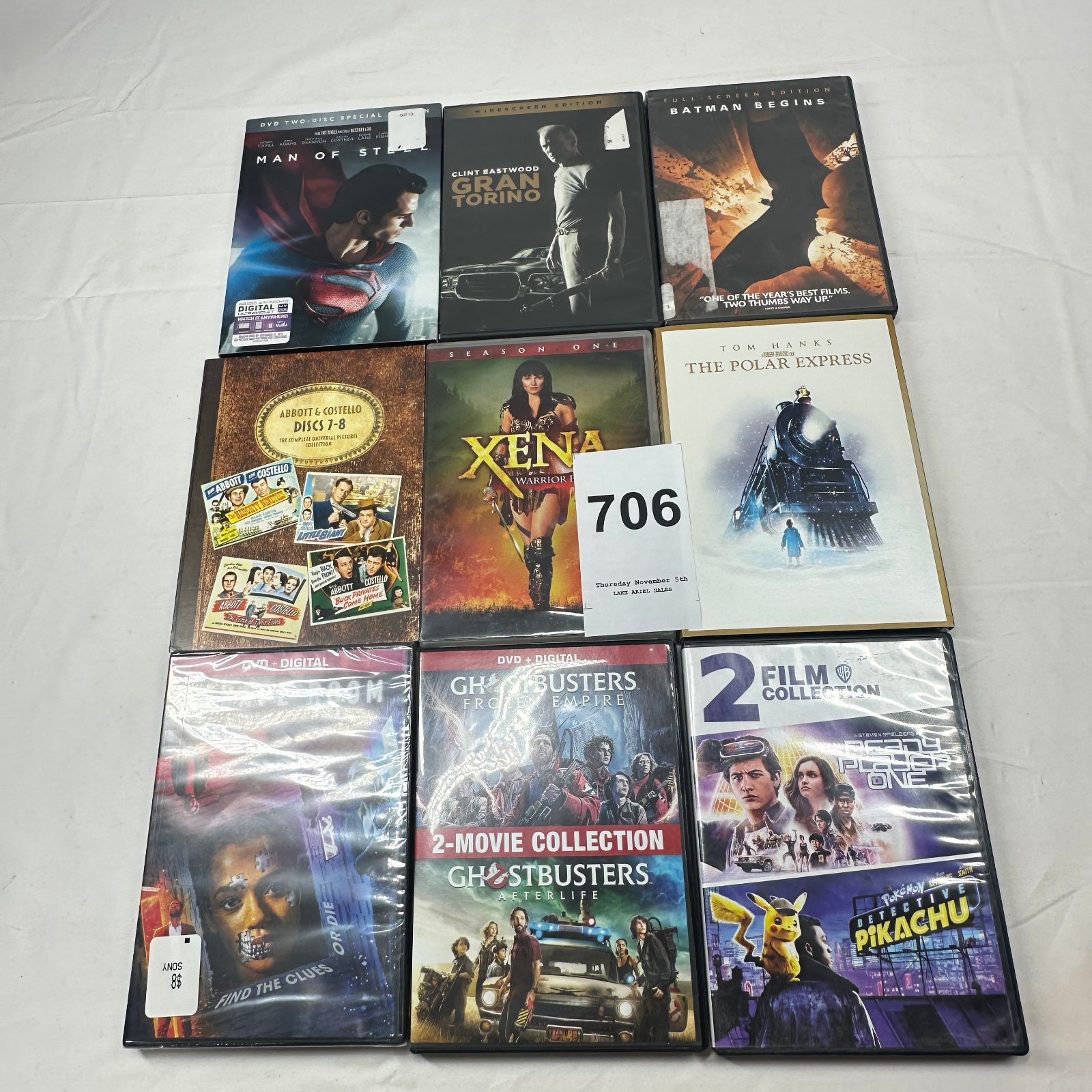 Lot 706: DVD lot of 9: Man of Steel, Gran Torino, Batman Begins, Abbott & Costello Discs 7-8, Xena Season One, Polar Express, Ghostbusters 2-Movie, Ready Player One/Detective Pikachu
