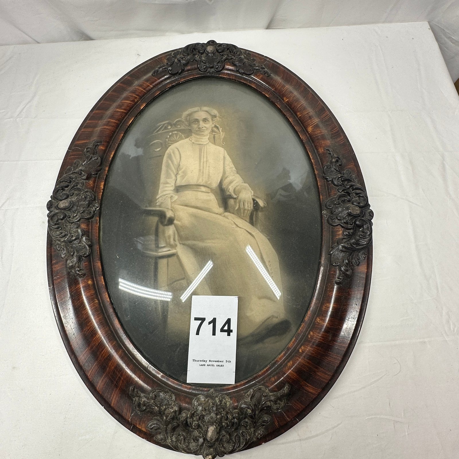 Lot 714: Carved wood oval frame with portrait print of seated women, rounded glass