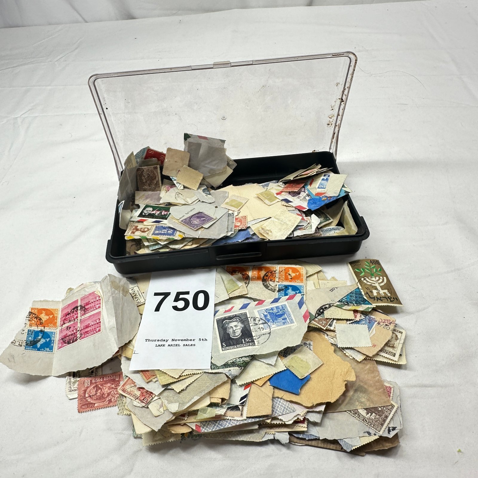 Lot 750: Mixed worldwide postage stamp collection lot, off-paper and on-paper, India, Italy, Spain, Austria, Israel, Hong Kong, in plastic storage case