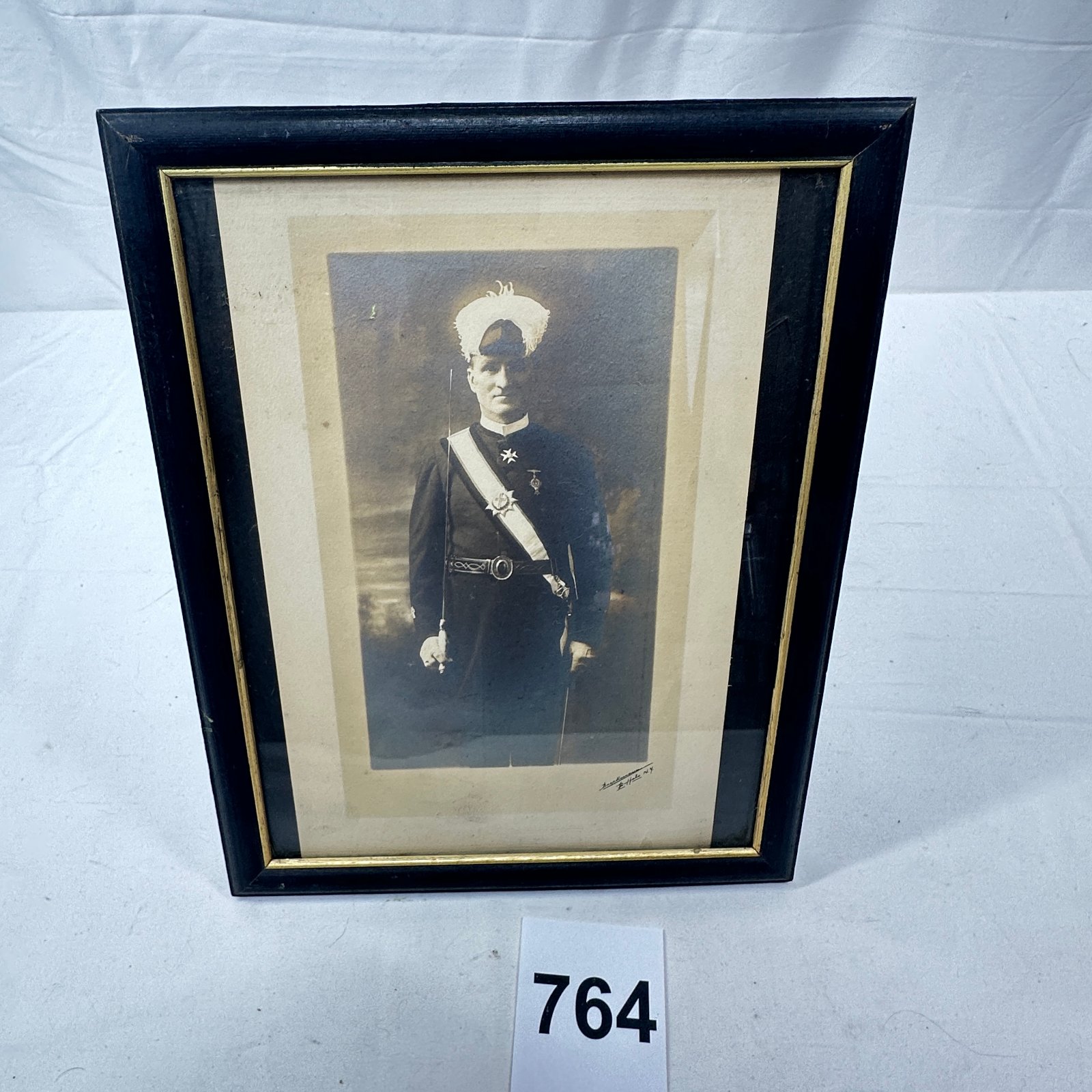 Lot 764: Early 1900s Boeckmann Buffalo NY sepia photograph, uniformed officer with sash, medals and sword, framed