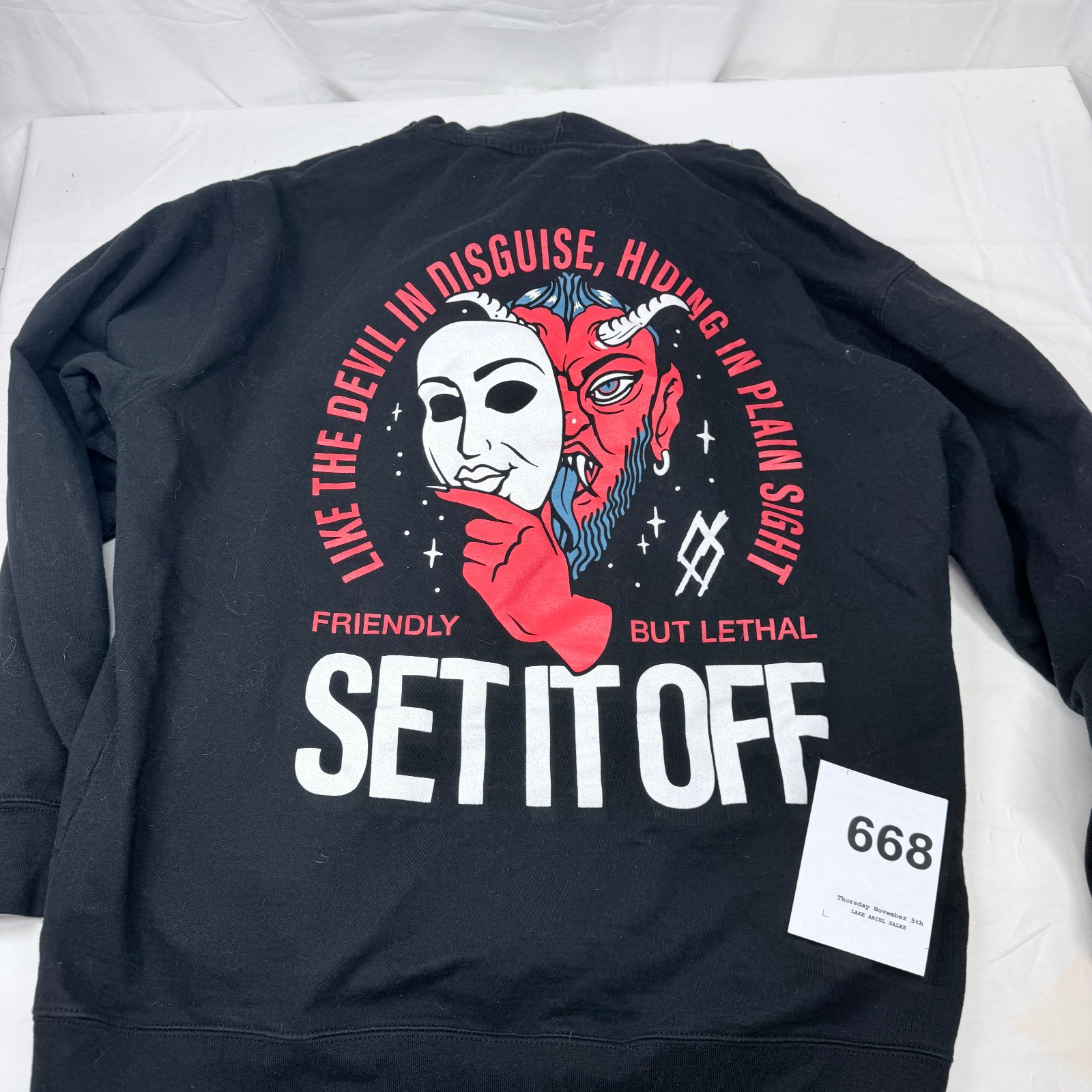 Lot 668: Set It Off band "Devil in Disguise" pullover hoodie, Friendly But Lethal graphic, size L
