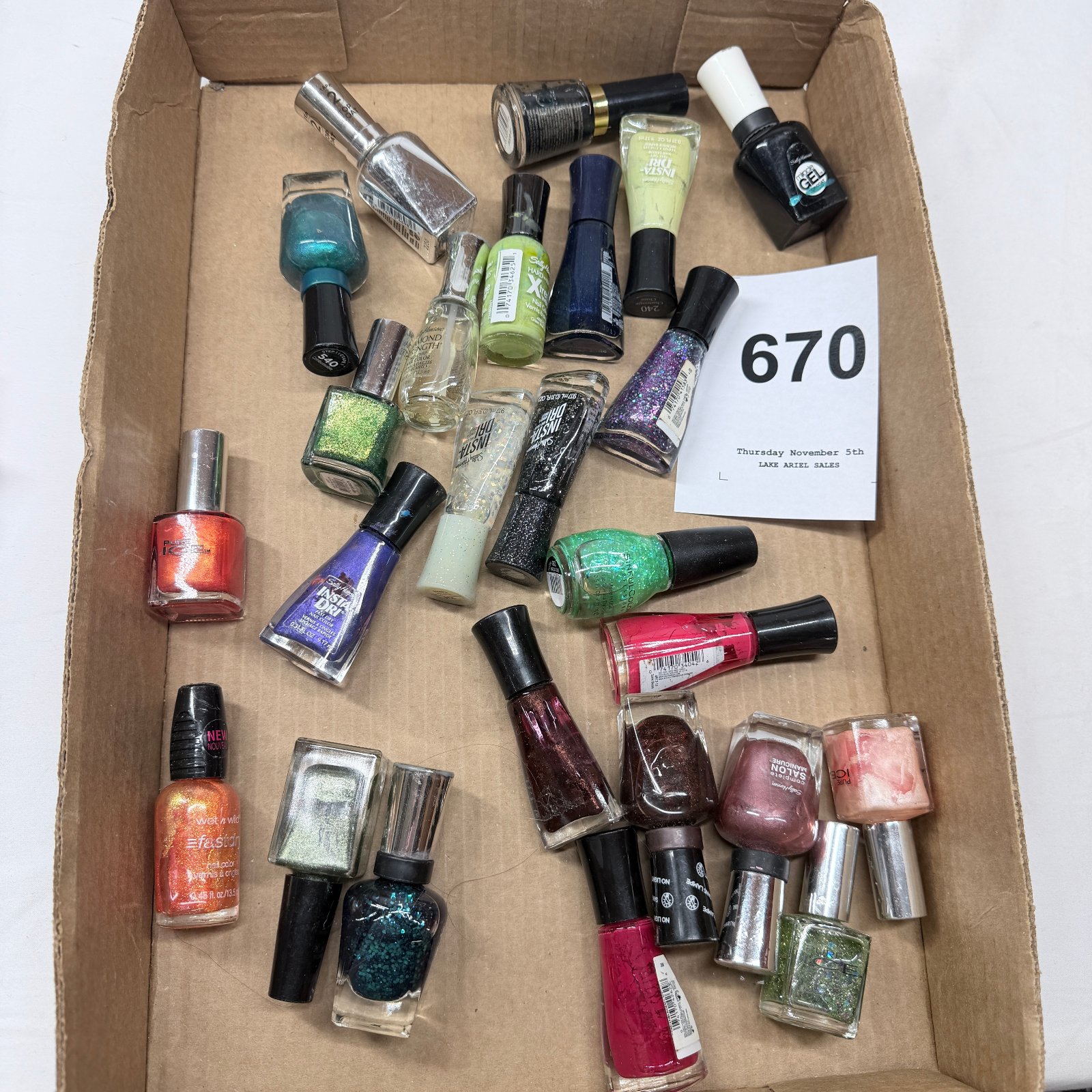 Lot 670: Mixed nail polish lot, Sally Hansen Wet n Wild Sinful Colors Pure Ice brands, assorted colors and finishes, ~30 bottles