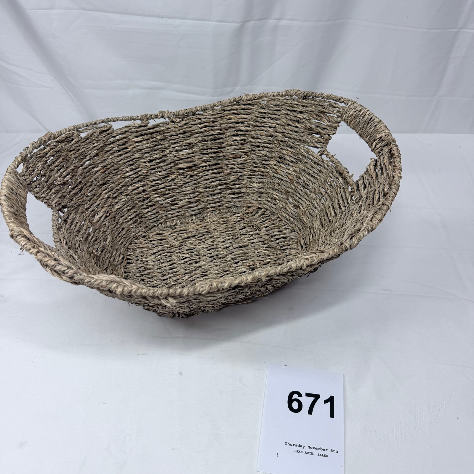 Lot 671: Seagrass woven oval basket with handles