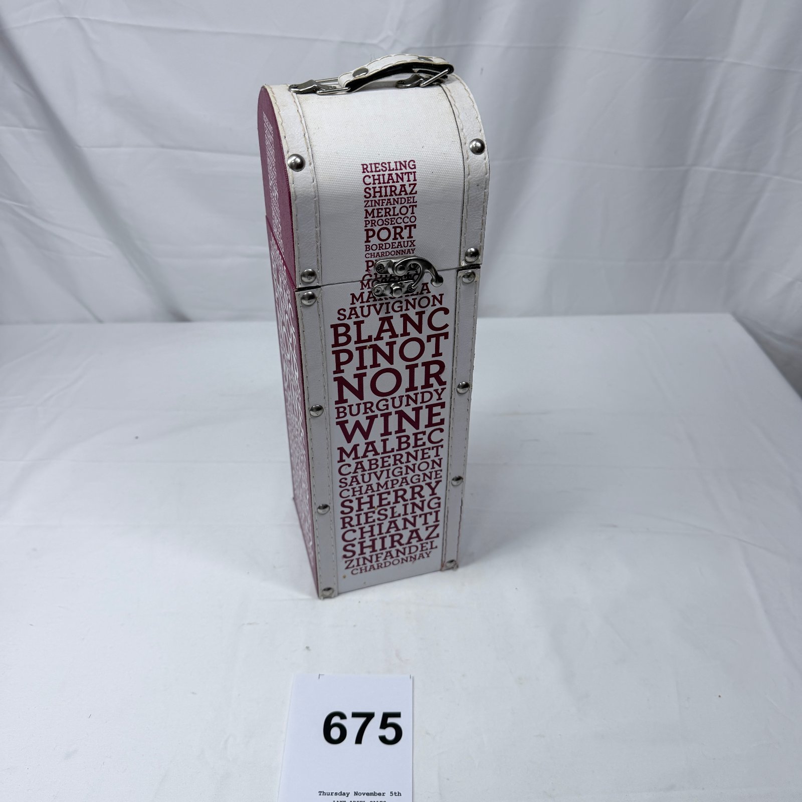 Lot 675: Wine-themed single-bottle presentation case, faux-leather dome-top trunk style with typography design