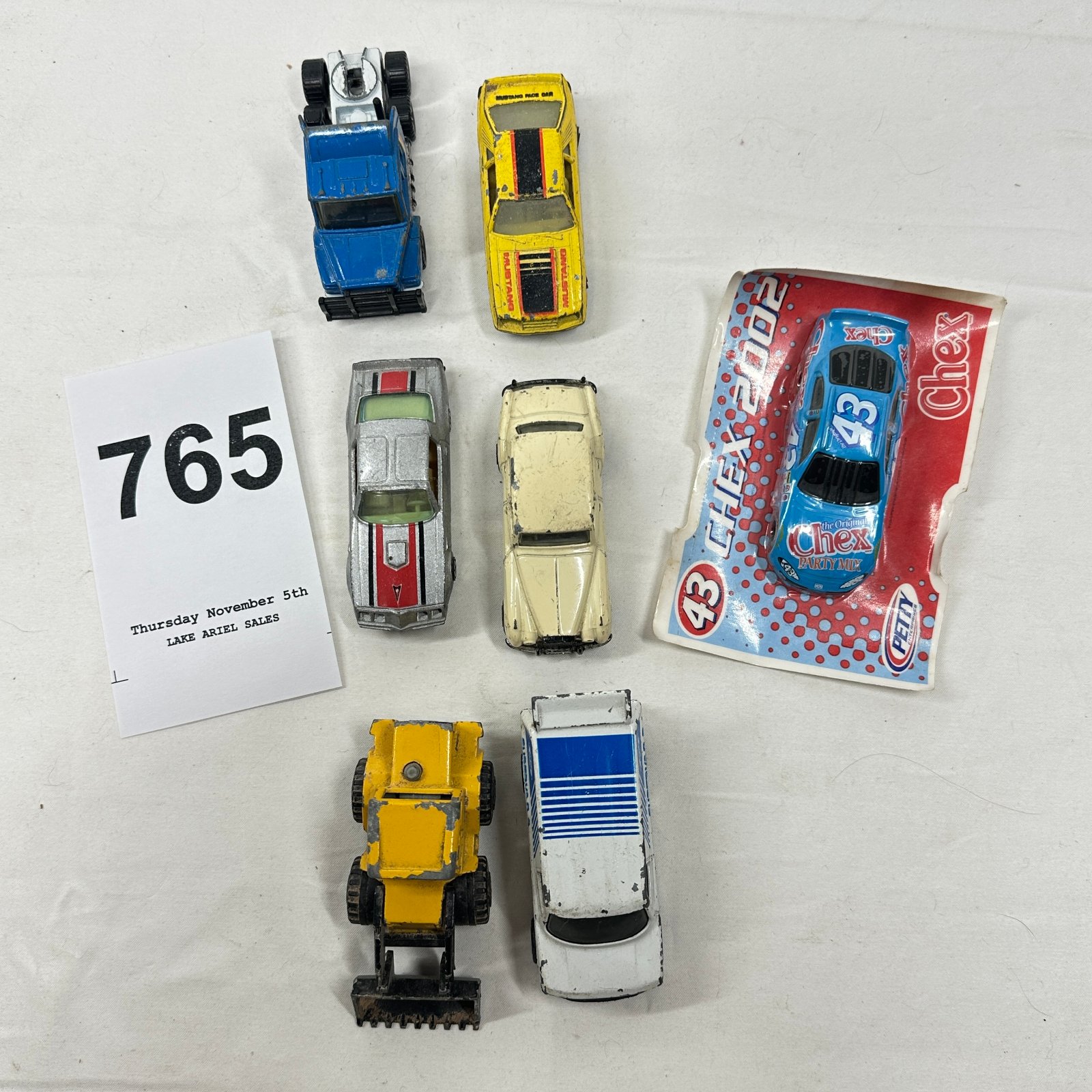 Lot 765: Diecast toy vehicle lot incl. Pontiac muscle car, Mustang, loader & 2002 Chex Party Mix Petty #43 NASCAR promo car