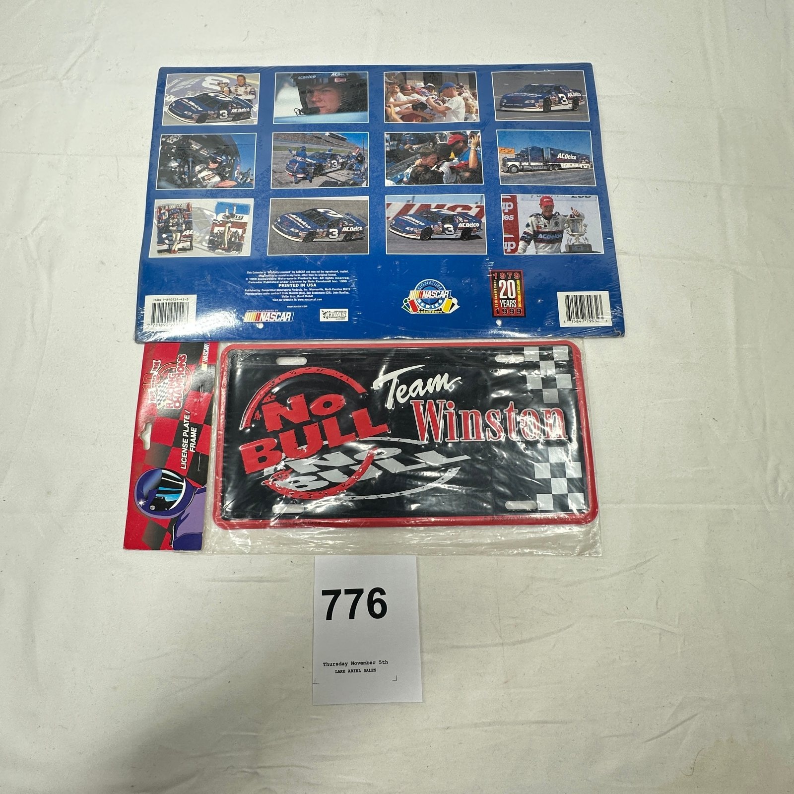 Lot 776: 1999 NASCAR Dale Earnhardt ACDelco 20th Anniversary calendar and "Team Winston No Bull 5" Racing Champions license plate frame set