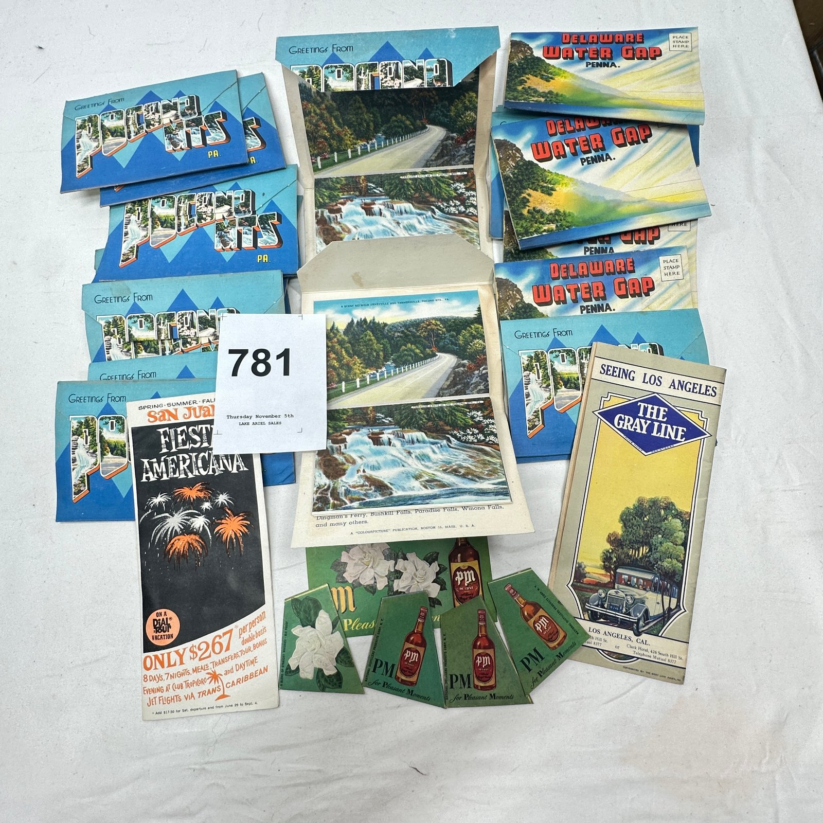 Lot 781: Mid-century souvenir travel ephemera lot: Pocono Mts & Delaware Water Gap PA fold-out postcard booklets, Gray Line LA brochure, PM Whiskey ads
