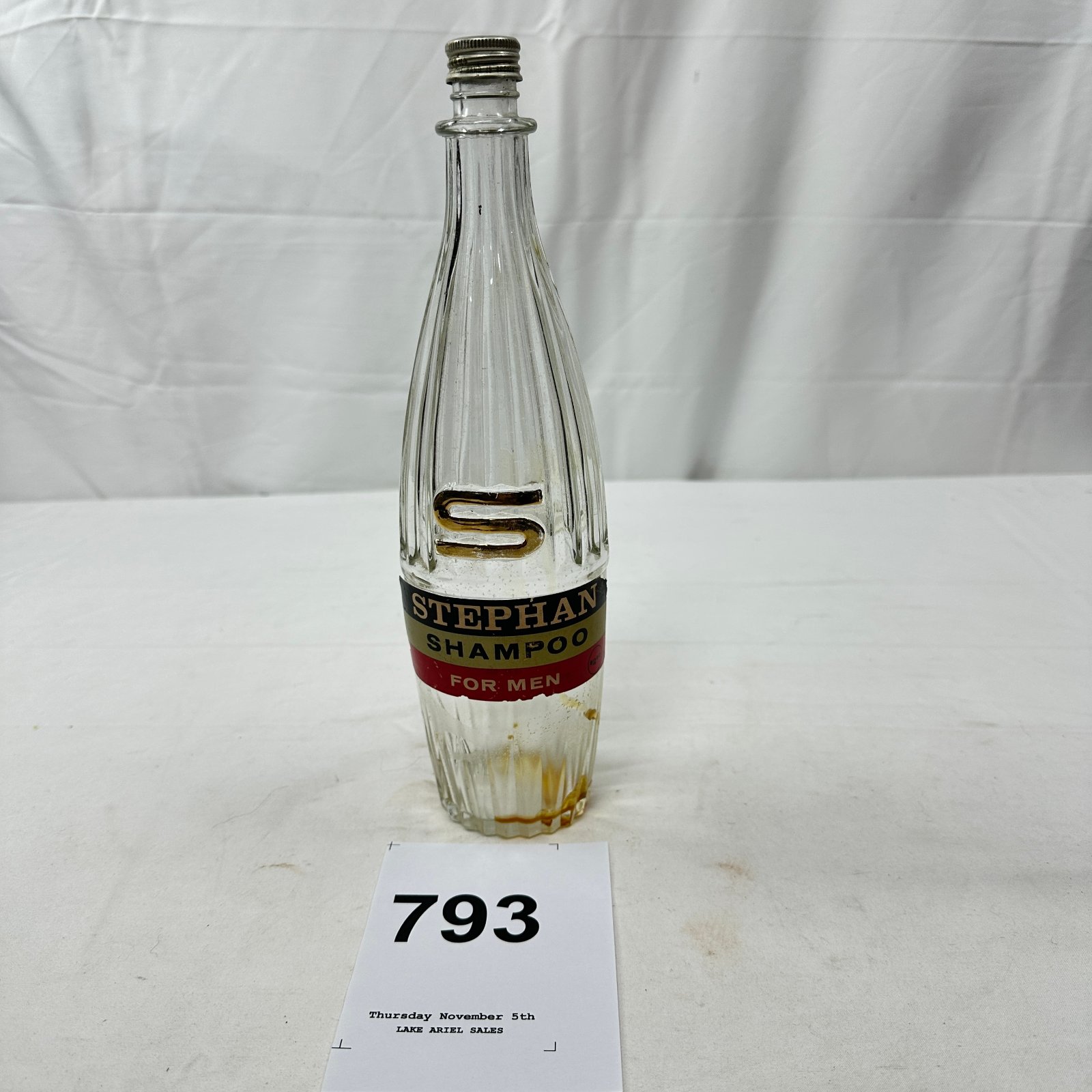 Lot 793: Mid-century Stephan Shampoo for Men bottle, The Stephan Co. Ft. Lauderdale FL, ribbed glass with gold "S" logo and screw cap
