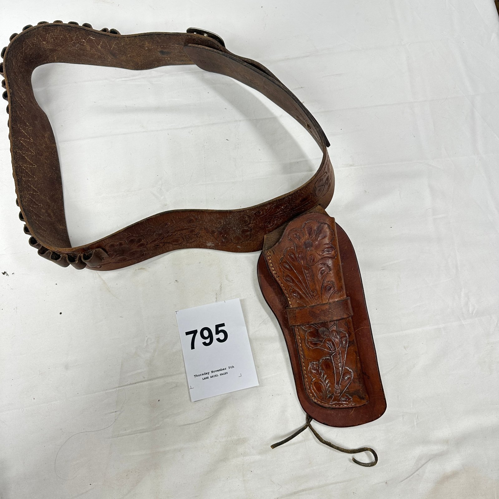 Lot 795: Hand-tooled leather cartridge belt and holster, floral tooled Western gun belt rig