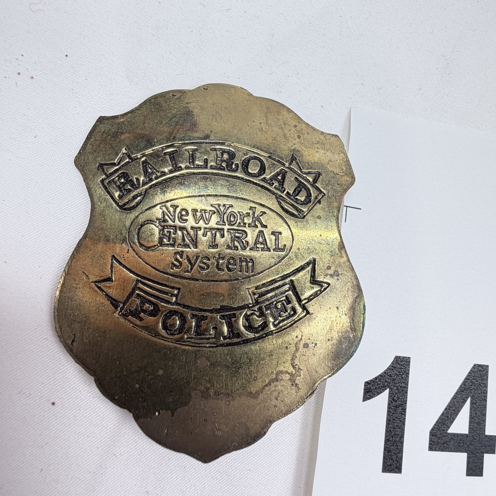 Lot 142: Early 1900s New York Central System Railroad Police brass shield badge, shield-shaped pin-back