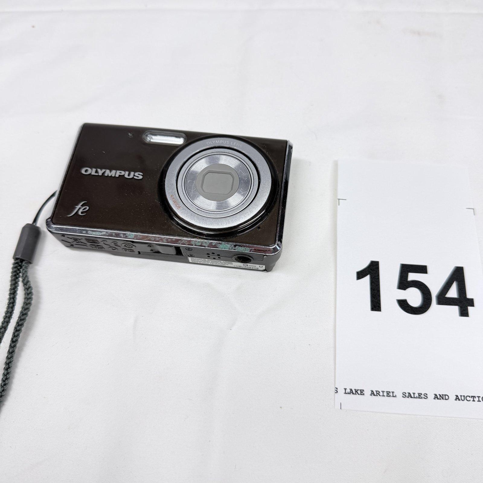 Lot 154: Olympus FE-series compact digital camera, brown body with lens cap missing