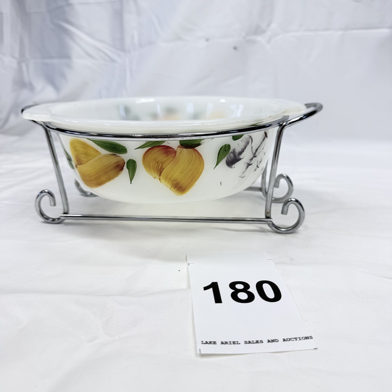 Lot 180: 1970s Anchor Hocking Fire-King "Fruits" 1-1/2 qt casserole dish with chrome cradle stand