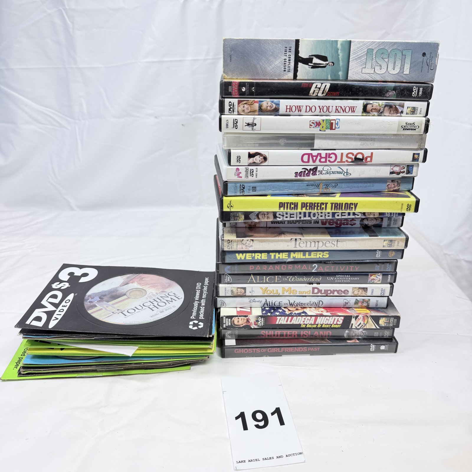 Lot 191: Mixed DVD movie collection lot (~30 titles): Lost Season 1, Shutter Island, Alice in Wonderland, Pitch Perfect Trilogy, We're the Millers, and more