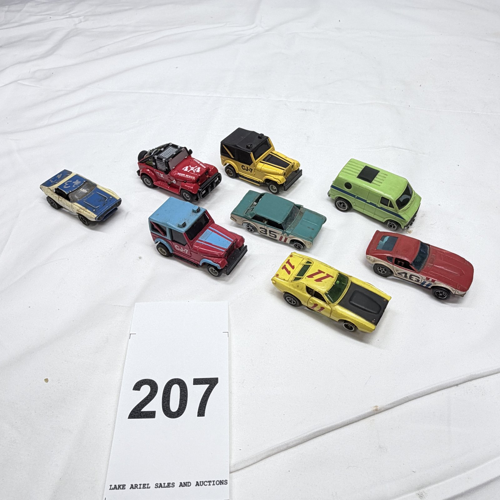 Lot 207: 1970s Hot Wheels/AFX lot: Datsun 240Z, Jeep CJ-7 x2, Ford Van, "Doom Buggy" 4x4, diecast/slot car muscle cars, 7 pieces