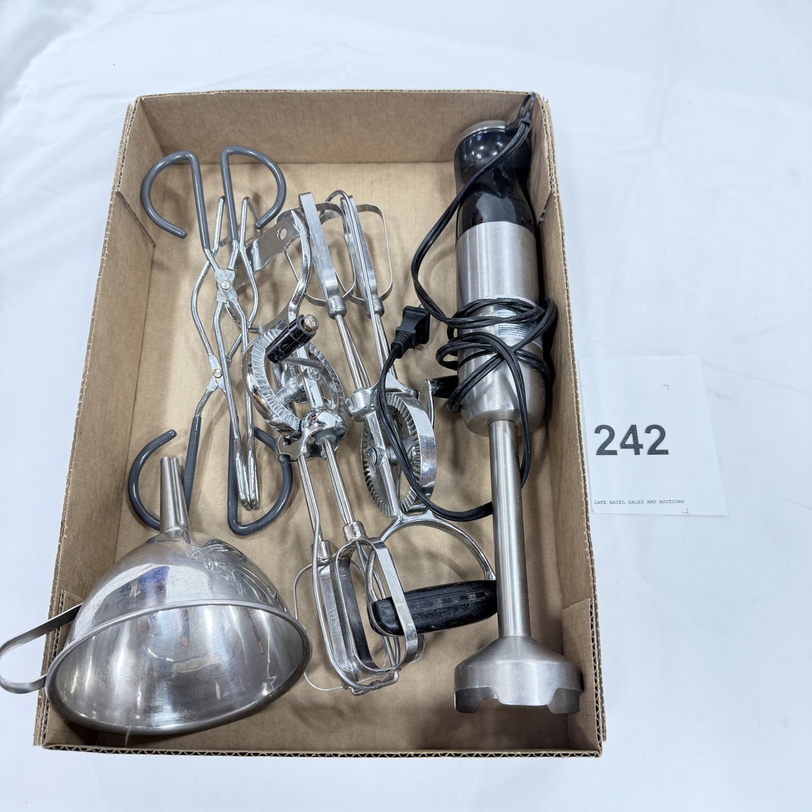 Lot 242: Kitchen tool lot: stainless immersion blender, 2 egg beaters, wire whisk, funnel/strainer, and tongs