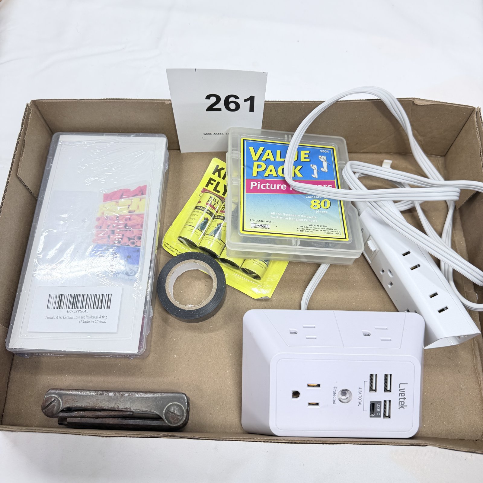 Lot 261: Household lot: Lvetek 4.2A USB surge protector, 3-outlet power strip, Pik-A-Nut "Value Pack" 80pc picture hangers, wire connectors, fly ribbon, electrical tape