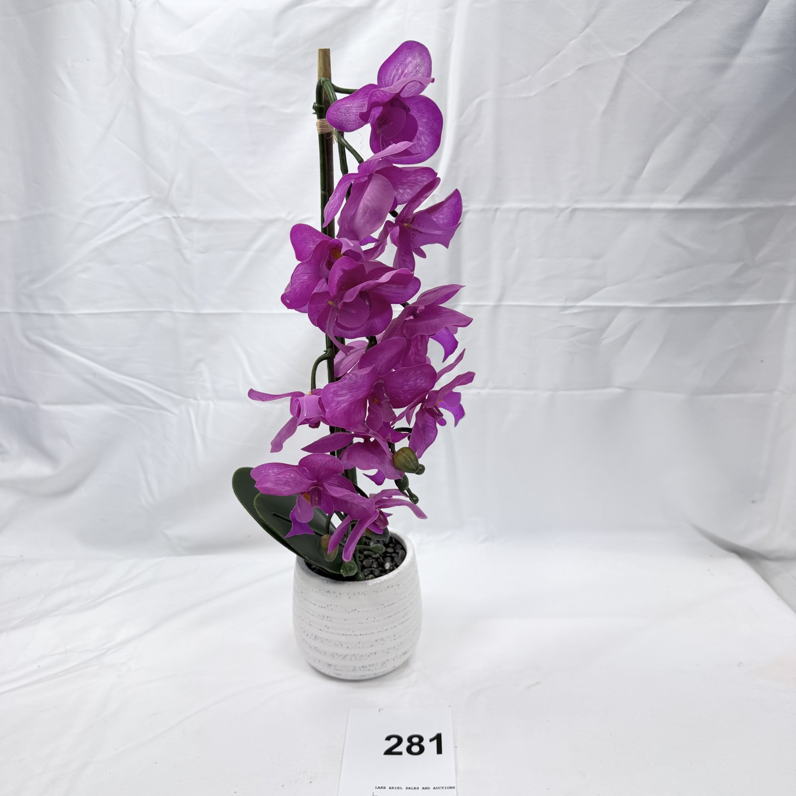 Lot 281: Artificial purple phalaenopsis orchid arrangement in white ceramic pot, faux silk floral decor