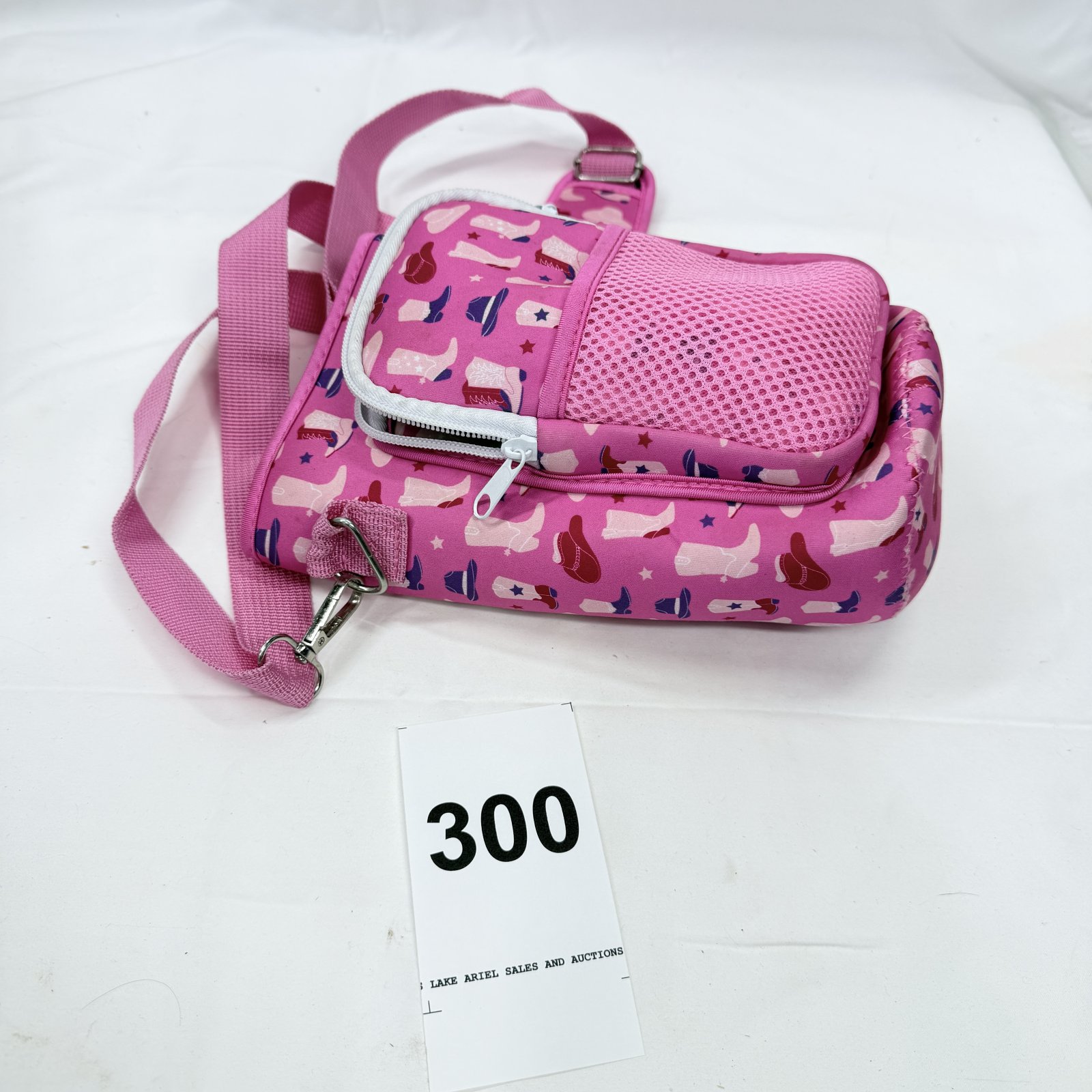Lot 300: Pink patterned crossbody Bottle bag with front zip pocket